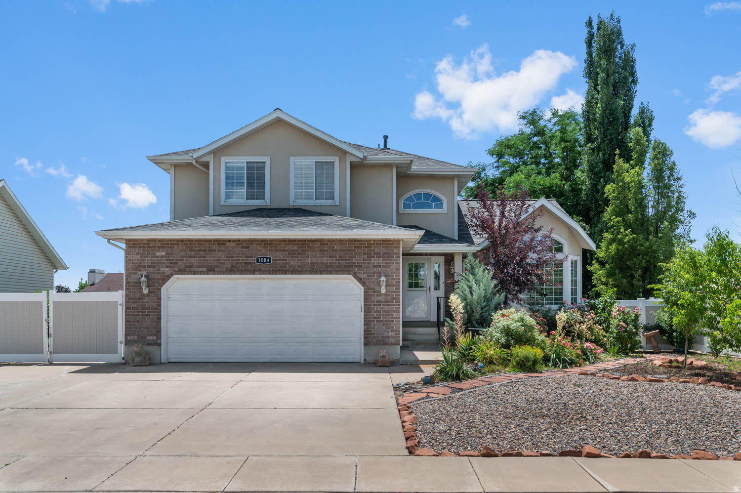 Well-maintained and thoughtfully updated spacious 2-story home in East Layton. Move in ready! Tucked away off Cherry Lane in the low-traffic Falcon Ridge neighborhood, with easy connection to Hwy 89 and Ogden or Salt Lake, and a close 8-minute commute to Hill AFB. *** 4-bedrooms, 3.5-bathrooms, approximately 3,010 square foot 2-story home with a 2-car garage, oversized RV parking pad with a drive-through gate to additional RV parking along the side of the home, built in 1994, on a .19 acre lot in East Layton. And a big plus ... no HOA! *** Improvements galore! 2025: New HVAC system with high-efficiency furnace, Newly planted - 3 cherry blossom, 2 apple and one peach tree. 2024: Secure storage room with vault door added in the basement. 2023: New roof, New tankless water heater, New main-level flooring, New glass shower and tub doors, New workbench and elevated storage shelves in garage, New raised garden boxes with drip-line irrigation added in the backyard. 2022: New xeriscape landscaping with integrated drip lines front and back, New backyard patio with an inset to add a firepit. *** The kitchen features Granite Countertops, Corner Pantry, Microwave, Dishwasher, Side-by-Side Refrigerator with In-Door Water & Ice, all of which stay with the home. A bay window in the kitchen dining area allows for more table space and lots of light. *** Beautiful newer laminate wood floors throughout the main level. Walk out from the Great Room with a gas log fireplace to the pergola-covered deck and the patio in the fully-fenced backyard. Private Office with custom sliding opaque-glass doors off the entryway that's spacious enough to accommodate two desks, plus a serene view of the front yard flower garden through the bay window. Main level laundry room and convenient half-bath. *** The primary bedroom features an ensuite bathroom with a jetted tub and oversized shower, nice sized walk-in closet, a bay window reading nook, vaulted ceiling, and laminate wood flooring. *** The fully-finished basement features another bedroom, full bathroom, den plus additional open space, and a beautiful kitchenette (just missing a range). The refrigerator and the bar stools at the kitchenette island stay. *** The garage features a workbench and elevated storage shelves. There's also a convenient side man-door. *** Other Inclusions: Water Softener, Window Coverings, Smart Thermostat, Workbench, Two Storage Sheds, Both Refrigerators (main kitchen and basement kitchenette), the Bar Stools at the basement kitchenette island, Neighborhood Little Lending Library at the curb in the front yard. There is an active UTOPIA Fiber connection to the home, and Xfinity is available, too. *** Davis School District: King Elementary, Central Jr High, Layton High School, NUAMES: Northern Utah Academy for Math, Engineering and Science. ***  Please be sure to explore all the media that accompanies this listing: 3D tour with floor plans and full photo gallery - including interior, exterior, and drone views - to see everything this delightful home has to offer! ***