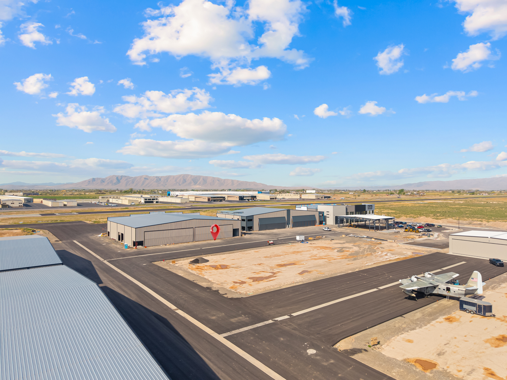 This huge 80x80 soon-to-be-completed airplane hangar at the Spanish Fork Municipal Airport offers an exceptional opportunity for aviation enthusiasts and investors alike. It features high-quality construction with full insulation, abundant natural light from south and west facing windows, and thoughtfully finished interiors including painted sheetrock, radiant tube heating, and modern lighting. The unit is also equipped with an ADA-compliant bathroom with shower, shop sink, RV dump and power, as well as expansive 18' x 80' trifold hangar doors, a 12' x 14' RV door, and a standard man door for convenience. Ownership includes the building itself (no land), with a long-term 50-year ground lease (30 years plus two 10-year renewals). Located in a rapidly growing area with quick freeway access and a welcoming general aviation community, this hangar presents a rare and valuable investment opportunity. Please note that a second hangar is also being sold which was completed in December 2025 - MLS # 2161786.