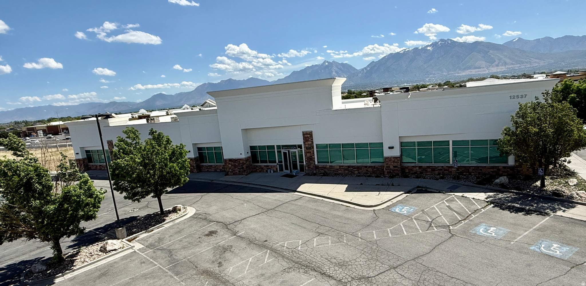 Rare opportunity to own or lease a highly visible single-tenant office/retail property in Riverton, Utah, located directly adjacent to In-N-Out Burger with a shared parking lot - providing an incredible built-in traffic draw and a unique advantage for future users. The property offers tremendous frontage and visibility along Bangerter Highway, making it an ideal location for retail, restaurant, or service-oriented businesses looking to benefit from the daily traffic generated by one of the area's most recognizable destinations.  The well-maintained building features approximately 75 offices and was previously utilized as a regional office facility by the Utah Department of Transportation, making it a functional and efficient office headquarters. The flexible layout allows an owner-user to occupy the space, lease it as a traditional office building, or explore the potential to create a mixed-use opportunity with office space combined with multiple retail or restaurant suites.  Opportunities like this are extremely rare - a standalone building of this size, with exceptional visibility, abundant parking, and direct proximity to a high-traffic national restaurant user. Whether you're looking for a corporate office location, an investment opportunity, or a property with redevelopment potential, this asset offers unmatched flexibility and long-term upside.  Owner/Agent