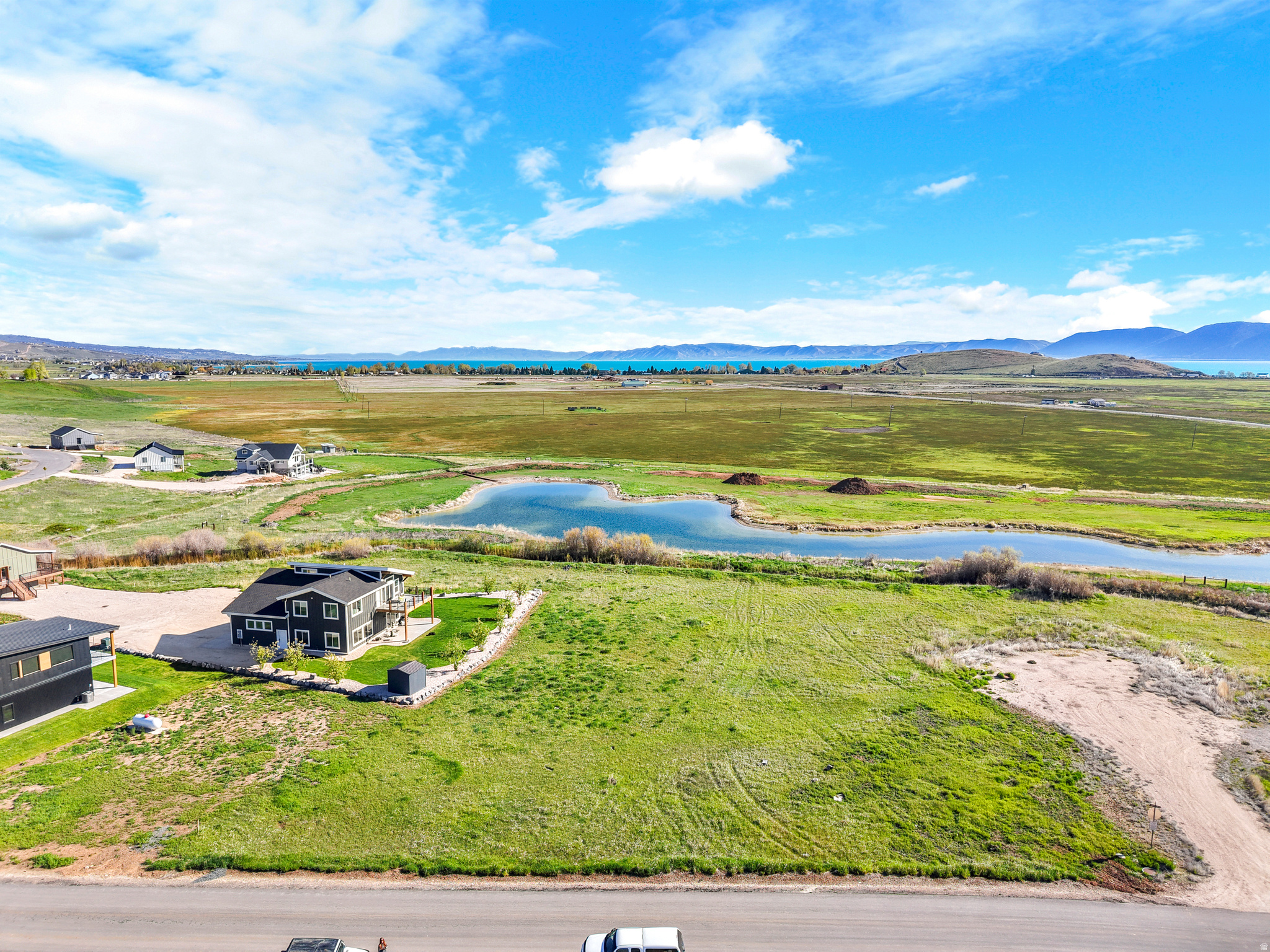 Corner flat lot close to Sweetwater Golf Course.  Short term rentals allowed!  Large 0.33 acre lot provides plenty of space for a large home, garage and lots of parking.  View of the lake, view of pond below (east) of property.  Country feel yet close to the city. Owners in the Sweetwater Golf Course HOA may be eligible to purchase a membership to Ideal Beach Resort.  Ideal Beach sets the price and rules for that membership,  please contact them for more information. Buyer to verify connection fees for sewer and water and power.