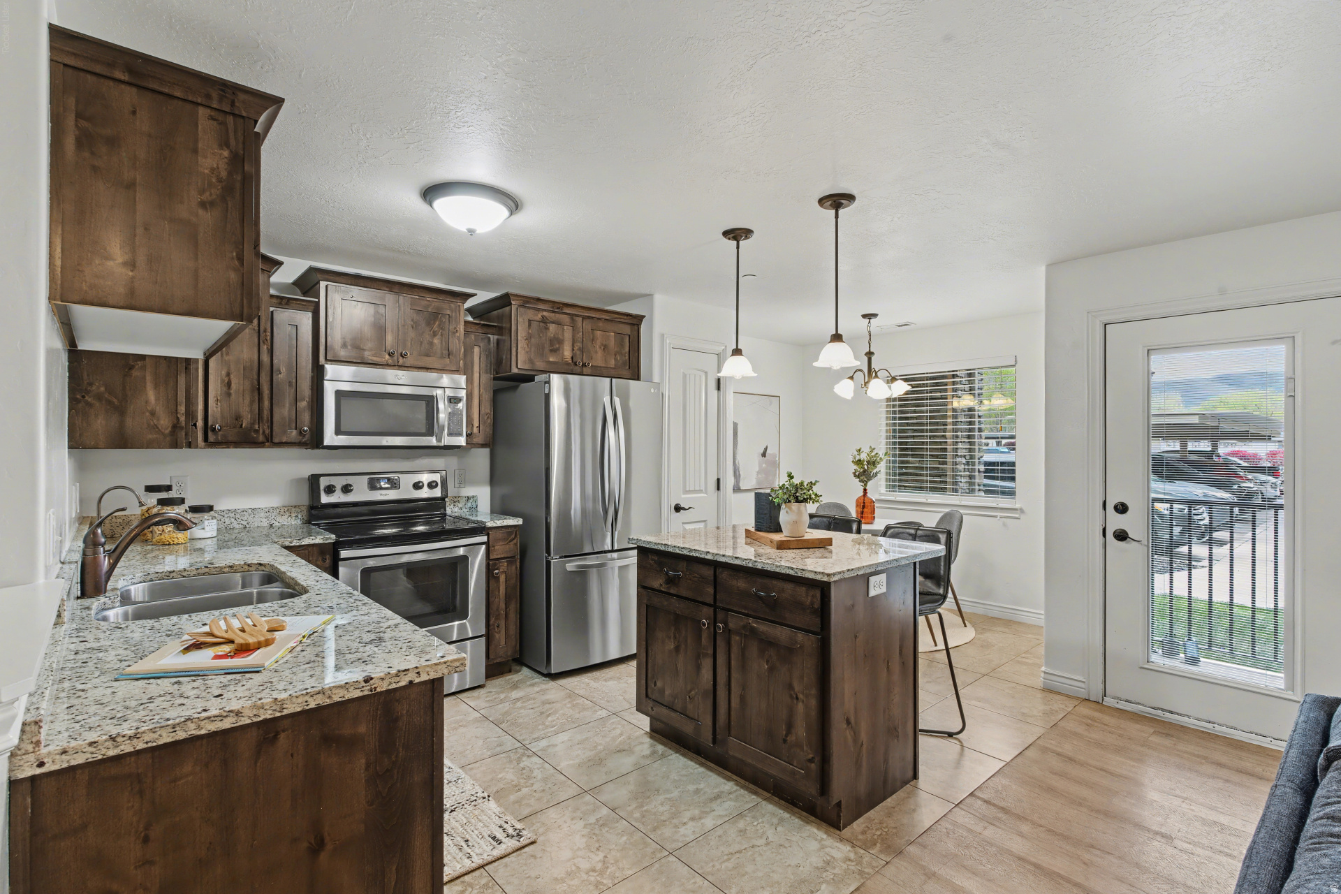 Don't miss this MAIN LEVEL 2 bedroom condo in the highly desirable Creekside Village! Ideal location with quick freeway access.  Inside you'll find hard surface flooring throughout, beautiful cabinetry, granite countertops, reverse osmosis tap,  and all kitchen appliances included.  Step out to your patio area for morning or evening relaxation, entertaining or pet enjoyment.  This unit stands out with BOTH a covered parking spot and a private GARAGE- a valuable feature in the community.  Enjoy amenities including a pool, clubhouse, gym, picnic and playground area and basket ball standard.  Utopia fiber is available.   This unit already has Rental capabilities!!! Schedule your showing now!
