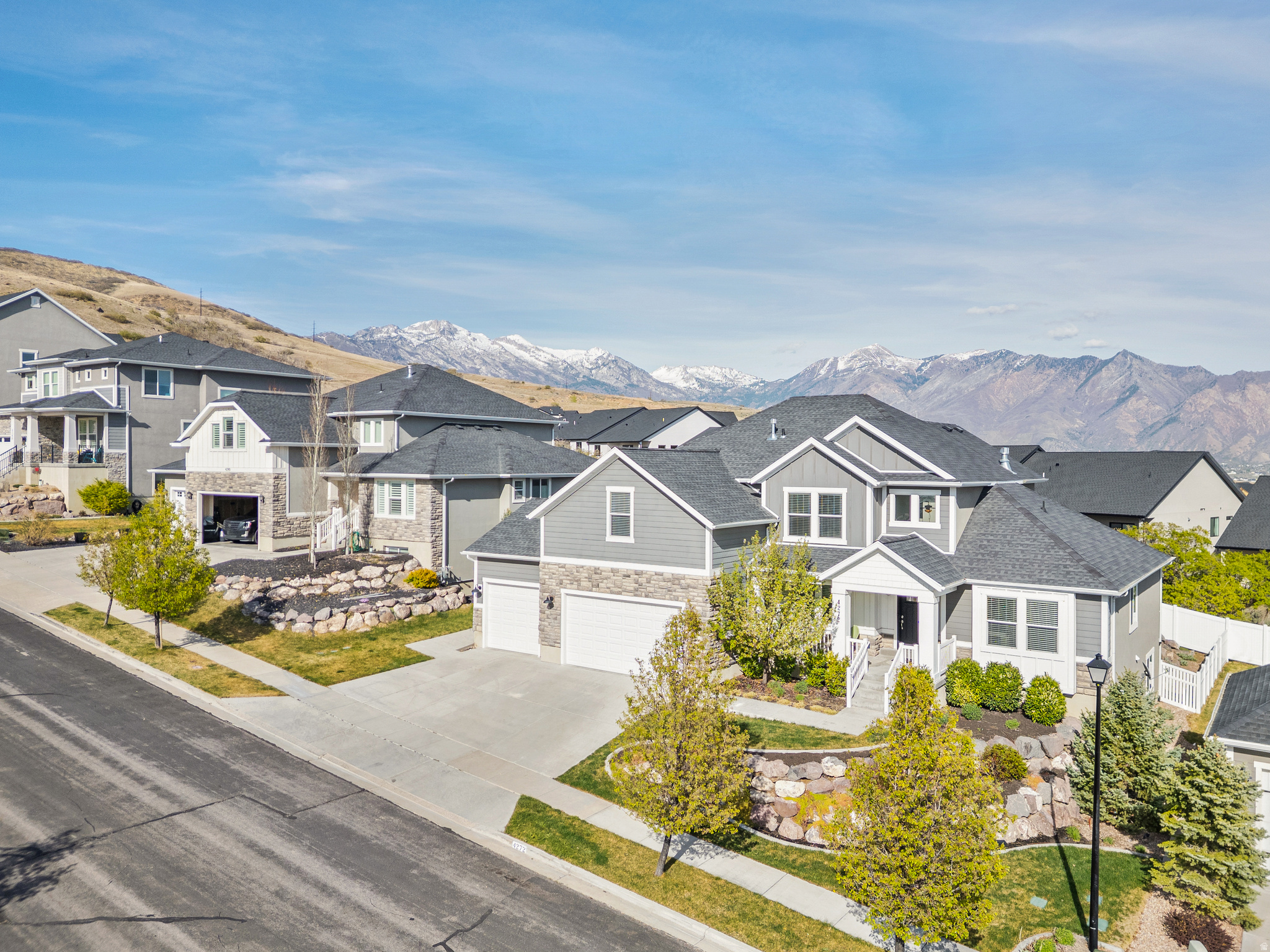 Awesome location.  Right by mountain access and the walking trails, 3 minutes from the freeway access. Functional design and built-in income potential. A separate mother-in-law ADU apartment with a private entrance provides a distinct living space, which has never been rented and remains in like-new condition, with an estimated rental potential of approximately $1,500 per month. The main level includes a large primary suite with a walk-in closet, allowing for true main-floor living. The multi-level bedrooms and upper family or TV room or upper den creates defined living areas with natural separation, supported by a dedicated mudroom with built-in storage, walk-in pantry, and a laundry room with pet door to the fenced back yard, designed for everyday use. The kitchen is finished with quartz countertops, white cabinetry, a subway tile backsplash, and stainless steel appliances. A large island with a deep sink connects directly to the main living area, creating an open and functional-and very big layout, with the new Lehi Temple just outside the back windows of the kitchen great-room; which features vaulted ceilings, a fireplace, and large windows that provide consistent natural light throughout the day. -Brand new carpet across the entire home. Hardwood flooring in main living areas, and tile in all bathrooms. Dual furnace systems, including a newly installed main furnace with an active warranty, and active radon mitigation professionally installed. Outdoor features include an elevated deck about 200 sq feet, with mountain views and partial lake views on the east side of the home. The property is located within close walking distance to trail access, connecting directly to an expanding network of hiking and biking trails leading toward Suncrest and Alpine. Immediate walkable access to outdoor recreation while maintaining proximity to established residential areas.
