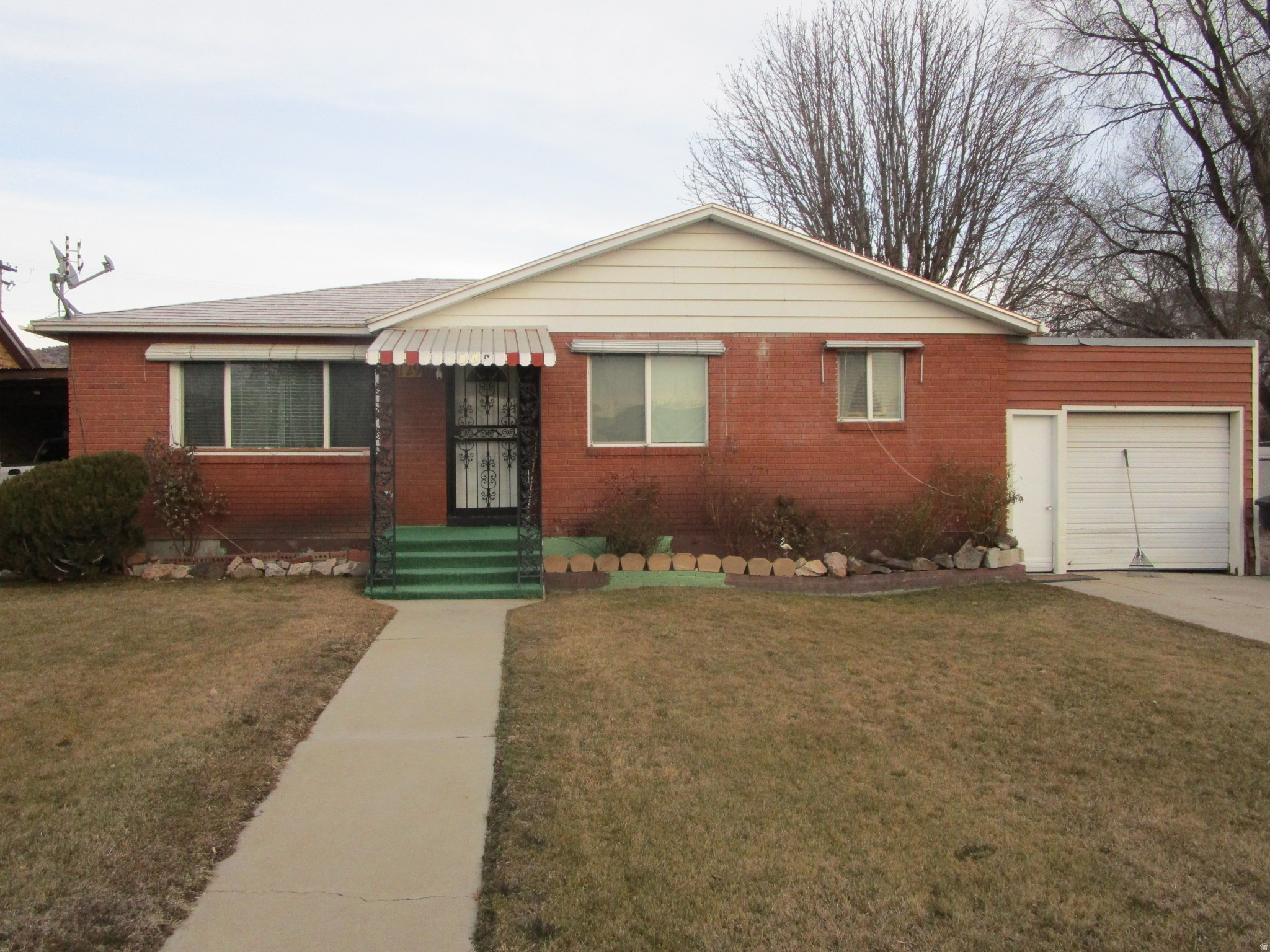 Cozy brick bungalow close to conveniences.  3 bedroom, 1 3/4 bath.   Main floor laundry with a bed and bath in the basement.  The basement, garage and outbuilding make great storage.  Full sprinkler system for the front and back yard.  Back yard is fully fenced, excellent for your dogs to play!!