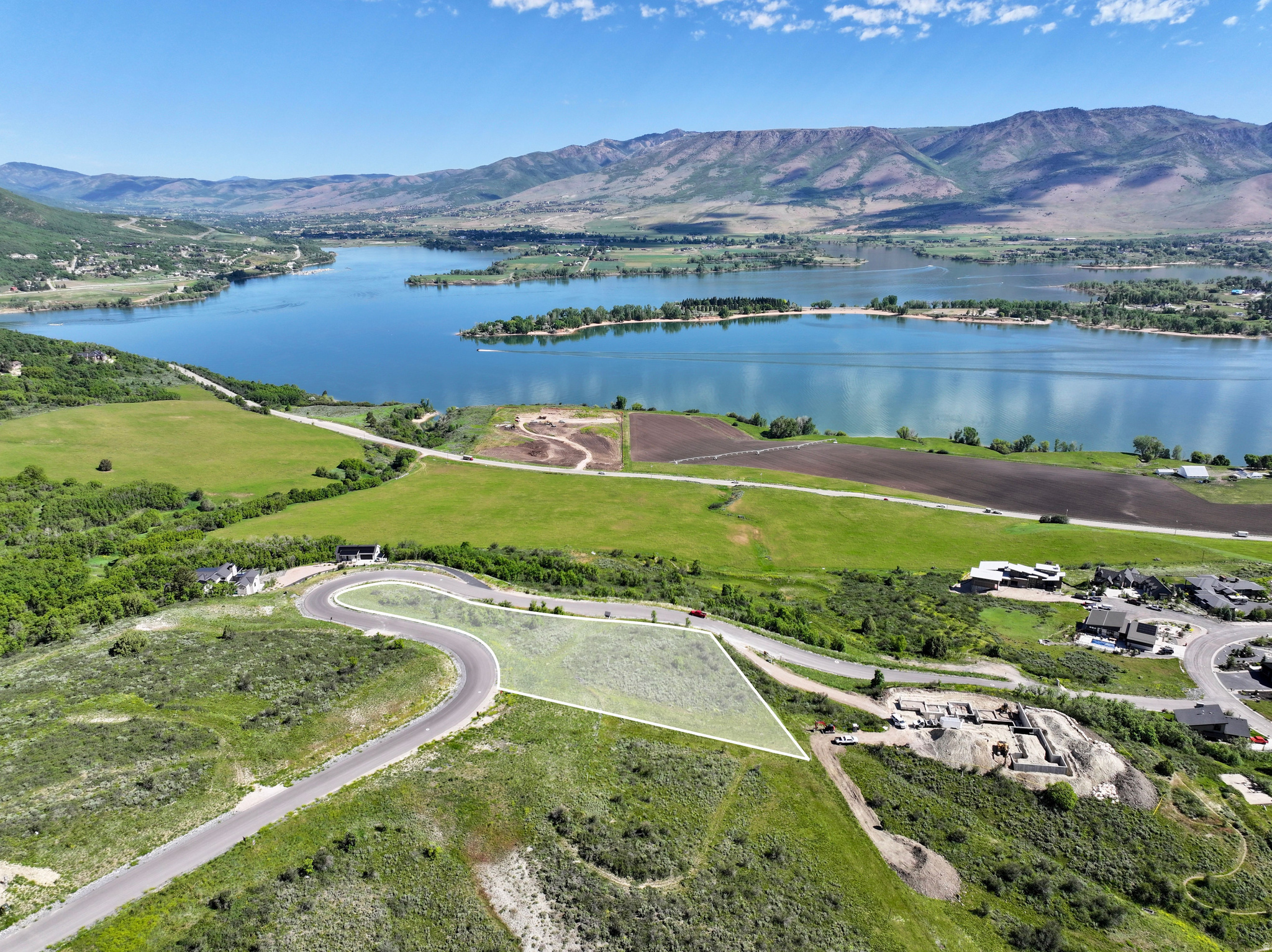 Welcome to Legacy Mountain Estates, Ogden Valley's premier luxury home community. If your priority is an extraordinary view of Pineview Reservoir, Lot 28 deserves your attention. Spanning 2.27 acres, this exceptional homesite captures panoramic views of the entire reservoir-an increasingly rare perspective-while also showcasing sweeping vistas across much of Ogden Valley, the valley floor, and the surrounding mountain peaks. The homesite features a mostly level building area with gentle slopes that are ideal for a walkout design, providing flexibility for a wide variety of custom home plans. Extensive road frontage and an easy driveway approach allow for multiple access and home placement options, helping you maximize both convenience and the property's remarkable views. Life at Legacy Mountain Estates means enjoying Ogden Valley in every season. Pineview Reservoir is just minutes away for boating, paddleboarding, fishing, and relaxing at the beach. Private community trails provide miles of hiking and mountain biking, while nearby Powder Mountain and Snowbasin Resort offer world-class skiing and snowboarding throughout the winter. Buyers will also receive a complimentary one-year membership to Wolf Creek Resort Golf Course, where championship golf is surrounded by spectacular mountain scenery. This fully improved homesite includes paid water and sewer connection fees, adding significant value as you begin planning your custom mountain retreat. With its unmatched panoramic lake views, build-friendly topography, and exceptional location, Lot 28 offers a rare opportunity to own one of Legacy Mountain Estates' most captivating homesites.