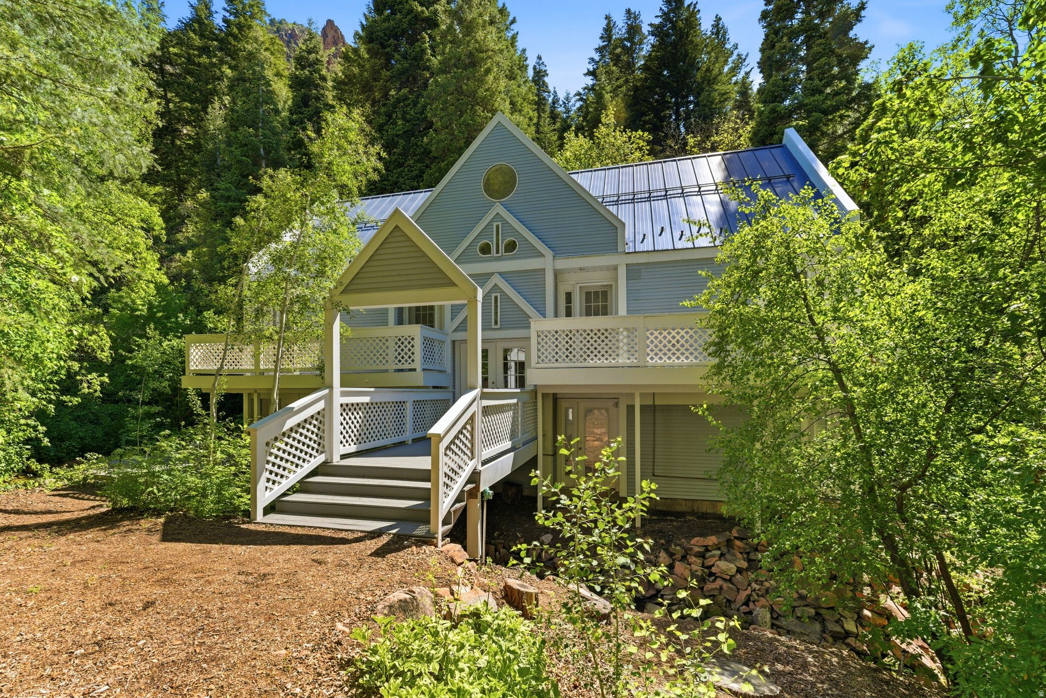 Tucked into the mountainside of the private, gated Mt. Aire community in Parleys Canyon, this rare retreat offers the perfect balance of seclusion and accessibility-just minutes from downtown Salt Lake City, Park City, and the international airport.  Surrounded by towering pines and set along one of Utah's most beloved canyon corridors, the home feels worlds away while remaining remarkably convenient for a quick dinner in town, a morning hike, or an afternoon on the slopes.  Thoughtfully positioned among the trees, the cabin embraces its natural surroundings with expansive decking, peaceful forest views, and a true sense of escape. A stunning creek runs through the property, creating a tranquil backdrop that can be enjoyed from multiple outdoor living spaces-where the gentle sound of water trickling by adds to the peaceful, immersive setting. A charming bridge walkway welcomes you to the home, setting the tone for the unique experience this property offers from the moment you arrive.  Inside, warm and inviting living spaces are complemented by a unique ladder-access loft-an imaginative and versatile retreat ideal for a reading nook, creative hideaway, or additional flex space. The home offers 3 bedrooms and 2 bathrooms, along with a fully finished basement featuring a cozy family room and dedicated laundry area, providing additional space for gathering, relaxing, and hosting.  Recent improvements enhance both comfort and livability, including new LVP flooring, brand new energy efficient windows throughout the home, newly installed kitchen appliances, fresh interior paint, and select electrical updates-allowing the next owner to enjoy the home with added peace of mind while still appreciating its original character and charm.  Lovingly built and thoughtfully maintained by the same family since 1992, the home reflects years of care and pride of ownership. The natural light, warmth, and inviting atmosphere throughout speak to a space that has been deeply enjoyed and is ready for its next chapter.  This property is recreationally zoned and offers a true seasonal mountain lifestyle. Access during winter months is limited, enhancing the sense of privacy and making it an ideal getaway for those seeking a quiet retreat immersed in nature.  Located within the Mt. Aire community, winter access is seasonal, with snowcat access available (buyer to verify options and availability).  Whether you're looking for a weekend escape, escaping the heat for cooler temps as a summer basecamp, or a place to unplug and recharge, this Mt. Aire cabin delivers an authentic mountain experience in one of the Wasatch Front's most treasured settings.  Additional notes: This cabin property includes its own 1500 gallon septic tank. The Mt Aire Rd is located right off of Parleys Canyon with its own private entrance gate, keeping the road and cabins secluded and quiet.