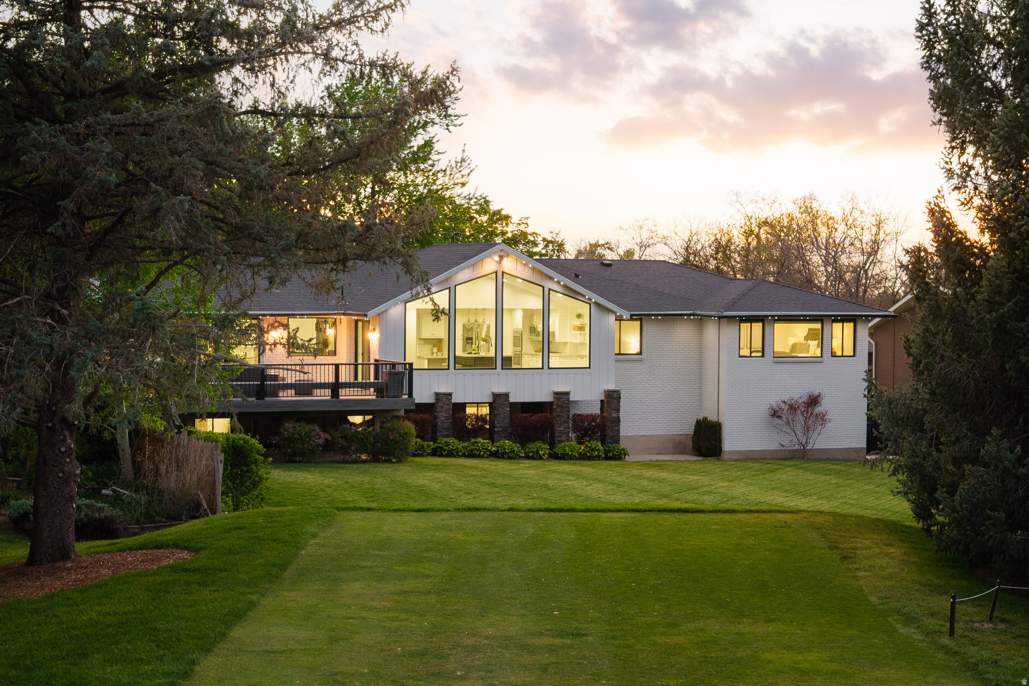 Fairway and mountain views set the tone at 8479 S Escalante Dr, a beautifully remodeled residence in Sandy's, positioned just behind the 6th tee box of Willow Creek Country Club. Dramatic vaulted ceilings and expansive windows pull the outdoors into the main living spaces, framing the greens, mature landscaping, and Wasatch backdrop in a way that gives the home an immediate sense of openness and calm. From the moment you enter, the setting feels connected to the landscape, with natural light, golf-course scenery, and mountain views creating a memorable backdrop for everyday living. Inside, 5 bedrooms and 3.5 baths unfold across 3,437 square feet of refreshed living space on a .29-acre lot. Built in 1974 and completely remodeled in 2015/2016, the home blends established neighborhood character with a clean, modern aesthetic. Open-concept gathering areas are filled with natural light and designed to feel comfortable, welcoming, and easy to enjoy. The redesigned kitchen anchors the main living space with a substantial quartzite island, matching countertops, and custom lighting, offering a polished centerpiece for cooking, dining, and conversation. Updated tile, lighting, sinks, faucets, fresh paint, and meticulous care throughout create a cohesive feel from room to room, while the three-car garage adds everyday functionality. A nearly 400 sq ft deck extends the living space outdoors, creating an inviting place for dining, relaxing, and taking in the fairway setting. Set in the Sandy, Alta, Snowbird, and Granite area of Salt Lake County, this 84093 address offers a memorable combination of golf-course scenery, mountain views, mature landscaping, and a thoughtfully remodeled interior. Schedule a private showing and experience the view from the deck in person.