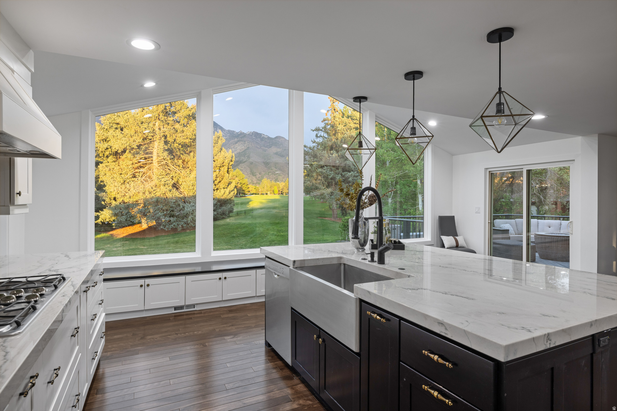 8479 S Escalante Dr in Sandy's WILLOW CREEK NO. 14 subdivision offers a standout golf-course setting just behind the 6th tee box of Willow Creek Country Club, with panoramic fairway and mountain views framed by dramatic vaulted ceilings and expansive windows. Listed at $1,650,000, this remodeled Sandy real estate opportunity combines a scenic .29-acre lot, mature landscaping, and an elevated indoor-outdoor connection in one of the area's most recognizable golf-course settings. This 3,437 sq ft residential home, built in 1974 and completely remodeled in 2015/2016, is listed with 4 bedrooms and 3 bathrooms. Interior highlights include a clean modern aesthetic, abundant natural light, open-concept living areas, and a redesigned kitchen with a substantial quartzite island, matching countertops, and custom lighting. The living spaces open to a nearly 400 sq ft deck overlooking the greens, creating a strong entertaining and relaxation setting. Additional features include updated tile, lighting, sinks, and faucets noted throughout, fresh paint, meticulous maintenance, a three-car garage, and mature landscaping that adds privacy and curb appeal. For buyers searching homes for sale in Sandy, Sandy homes under $1,750,000, 4+ bedroom homes in Sandy, WILLOW CREEK NO. 14 homes for sale, or homes for sale in Salt Lake County near the Sandy/Alta/Snowbird/Granite area, this property delivers a compelling combination of views, remodel quality, lot setting, and golf-course proximity. Review the professional MLS photography and existing virtual tour, then schedule a private showing to experience the fairway and mountain views in person.
