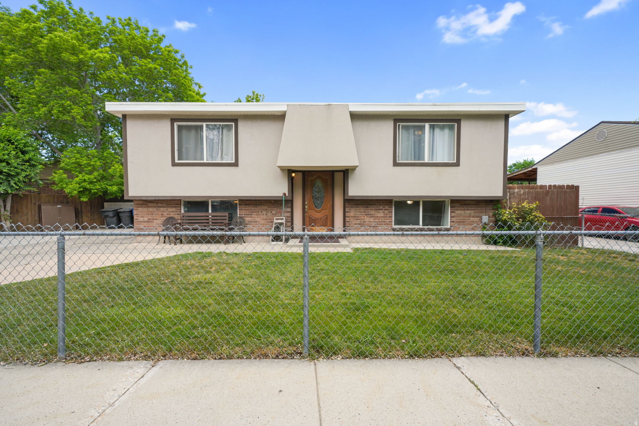 This solid, well-maintained Taylorsville home offers an exceptional amount of space and a rare layout for under $450,000. With 1,894 square feet of living space, the home is ideal for anyone looking for flexible living arrangements, including a potential mother-in-law setup or separate living quarters.The main level features a comfortable, functional floor plan with direct access to a large back deck-perfect for summer BBQs, entertaining, or simply enjoying the backyard space. Downstairs, the fully finished basement includes its own private exterior entrance, creating excellent separation and versatility. The lower level offers two bedrooms, a bathroom, a functional second kitchen, and a cozy living area, making it a great option for extended family, guests, or additional living flexibility. Outside, the spacious lot includes a large driveway with ample parking for multiple vehicles, trailers, or recreational toys. Located in a quiet, established neighborhood, this home is just minutes from regional parks, local dining, Valley Fair Mall, and Fashion Place Mall. Commuting is convenient with quick access to both I-15 and Bangerter Highway. If you're searching for an affordable, dependable home with flexible living space, a great yard, and a convenient location, this one deserves a closer look.