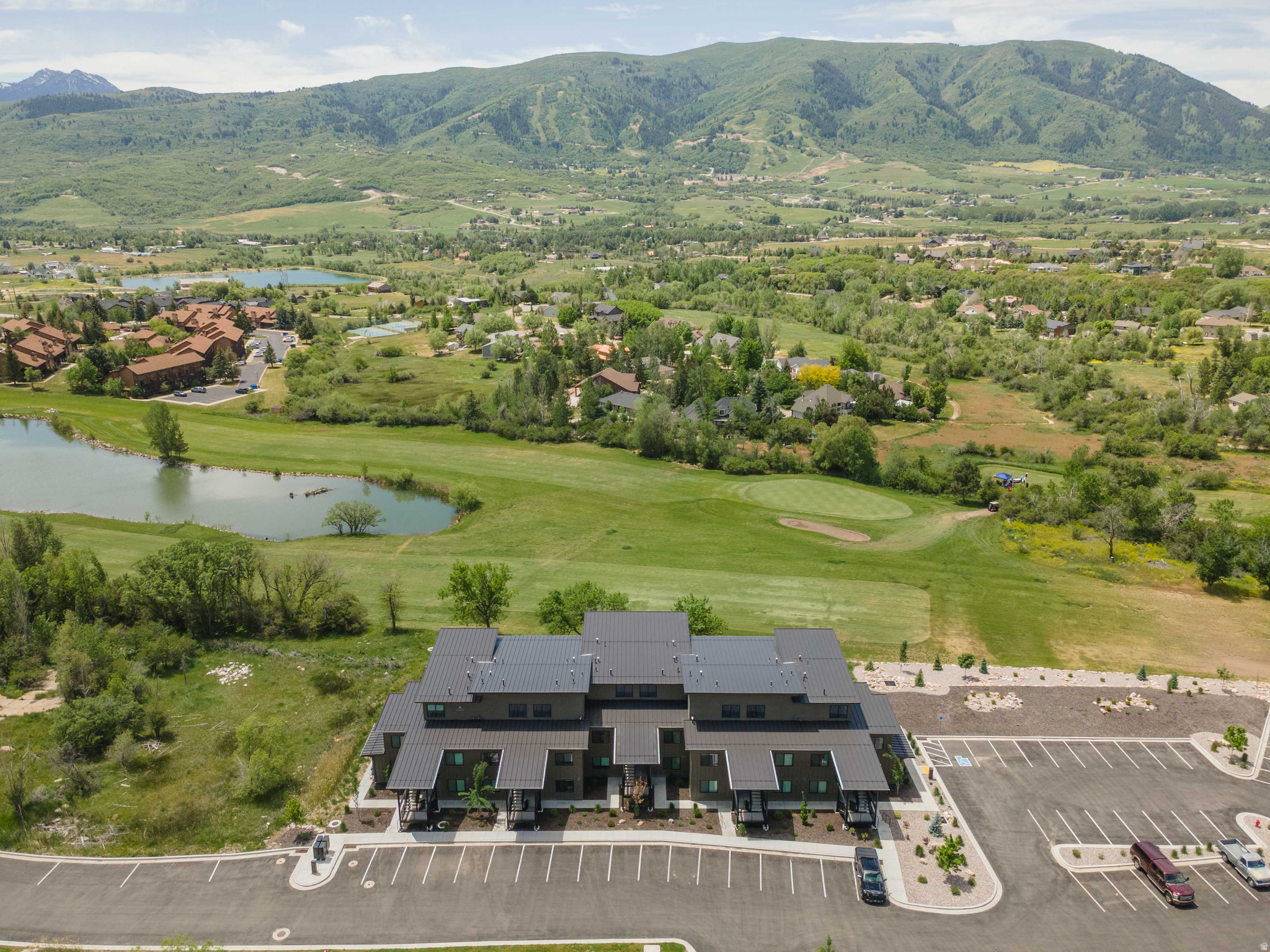Experience mountain luxury at its finest at The Pointe @ Wolf Creek Resort. This high-end, main level, condominium is nestled along the Wolf Creek Golf Course between the 10th and 11th fairways, in the heart of Eden. This one-bedroom condo is fully furnished and ready to enjoy, featuring a private patio w/hot tub, an open-concept layout, and a kitchen with stainless-style appliances, as well as custom quartz countertops and cabinetry. The great room welcomes an abundance of natural light with floor-to-ceiling windows that frame breathtaking views in every direction. Step outside to your private hot tub and savor year-round beauty. This turnkey condo is perfect as a primary residence, a tranquil retreat, or a savvy investment.  Ask about rental history. Community amenities include a welcoming fire pit along the creek and outdoor common space for everyone to enjoy. Located less than an hour from SLC International Airport, with convenient access to Wolf Creek Golf Course, Pineview Reservoir, Powder Mountain, Nordic Valley, and Snowbasin ski resorts. Attention to detail is evident throughout: a cozy fireplace, a gas grill and bar overlooking the golf course, private hot tub, upgraded lighting, a coffee bar, and a ski wall. These owners have thought of everything. Explore the details in the pictures and schedule your tour today - (sleeps 4) - Nightly rentals allowed All information is provided as a courtesy. Buyer and Buyer's agent are to verify all information to their own satisfaction.