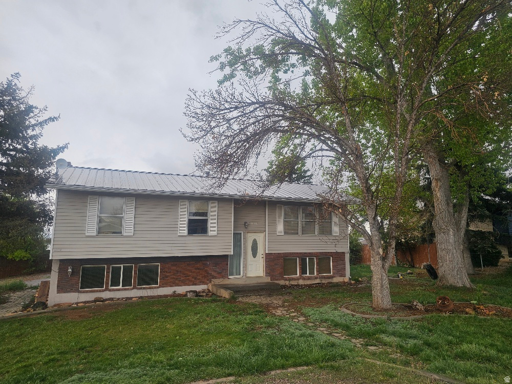 Opportunity awaits in this highly sought-after Maeser location! This 4-bedroom, 2-bath home sits on a spacious corner lot surrounded by mature trees and established landscaping. With generous square footage, an attached garage, and a full basement featuring a separate entrance, the property offers excellent potential for renovation, rental income, or investment opportunities.  Being sold AS-IS, the home will require repairs and updates, making it ideal for investors, flippers, or buyers looking to build equity and customize a property in a desirable neighborhood. Bring your vision and make this home your own!  Square footage and lot size are provided as a courtesy estimate from Uintah County Property Records. Buyer is advised to verify all information. Please allow a 24-hour notice for all showings.