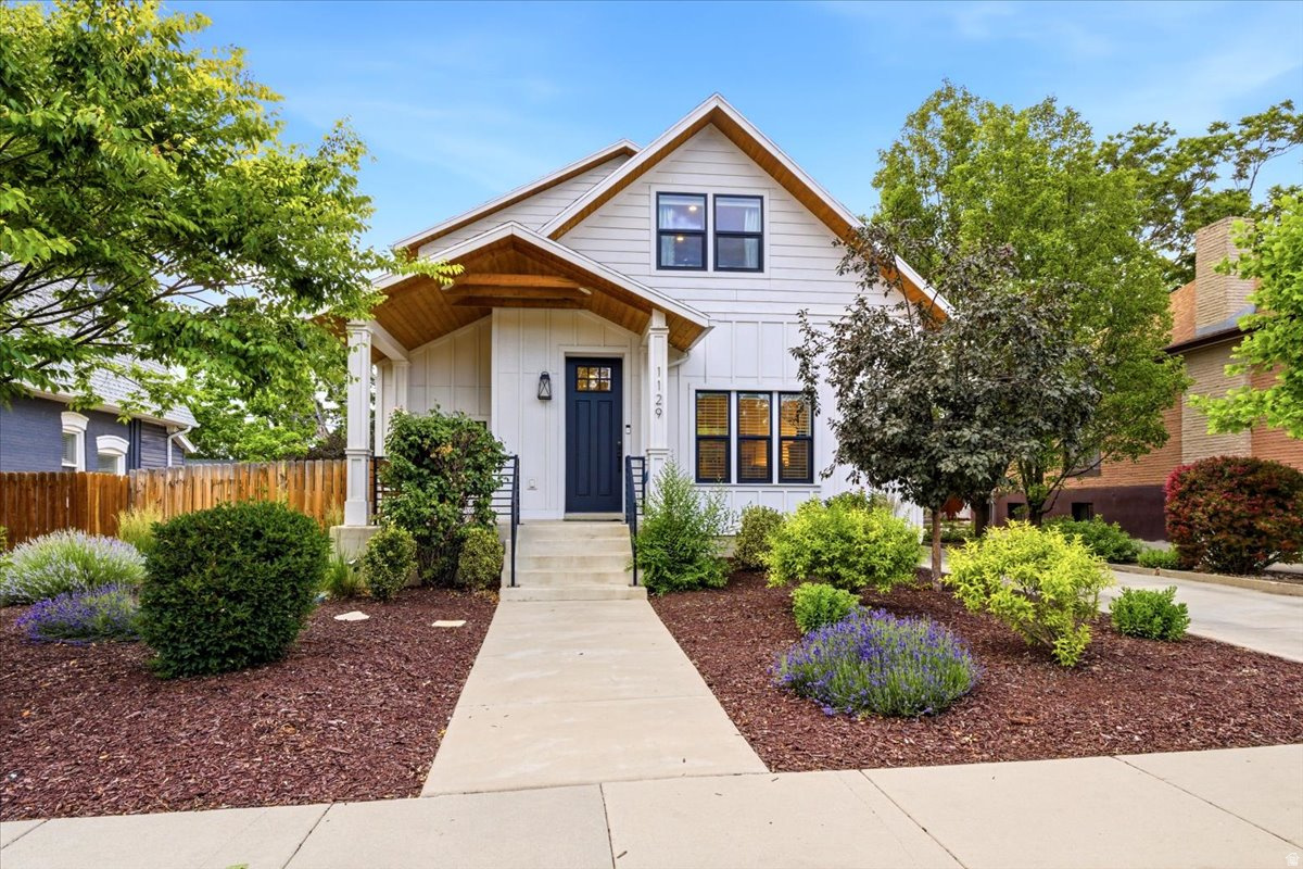 Every detail of this exceptional home was thoughtfully upgraded during a fully permitted 2017 remodel. Since then, it has served as a lightly used second home, keeping it in like-new condition. The exterior is a picture-perfect example of a Modern Farmhouse; classic white board and batten is accented with black trim, recessed lighting, and eye-catching wood soffit. The elegant aesthetic continues throughout the interior. Natural textures are beautifully incorporated in every room. Engineered hardwood flooring, custom wood beams and posts, and organic tones all add to the home's warm atmosphere. The inviting living room flows seamlessly into the adjoining dining area. Carrera marble countertops, a stained wood rangehood, and white shaker cabinets adorn the kitchen. A large island provides extra space for cooking and entertaining. There is ample storage, including a sizable pantry, which is extremely rare in this neighborhood. Also on the main level is the impressive primary bedroom with French doors to a walkout deck. The luxurious ensuite provides a spa-like retreat with a dreamy soaking tub, walk-in shower, and double vanity. A second bedroom, bathroom, and a back entry way with laundry complete the main level. The upper level includes a grand family room, lovely third and fourth bedrooms, bathroom, and additional storage. Situated squarely between two of SLC's coolest areas, Sugarhouse and 9th & 9th, the location is as good as it gets. You'll be able to leave your cars in the detached two car garage on a regular basis with fantastic shops, restaurants, and parks all within walking distance. Roosevelt Avenue is an unassuming street, with friendly neighbors who greet each other as they enjoy the McClelland Trail. This comfortable and contemporary home comes with an unbeatable location.