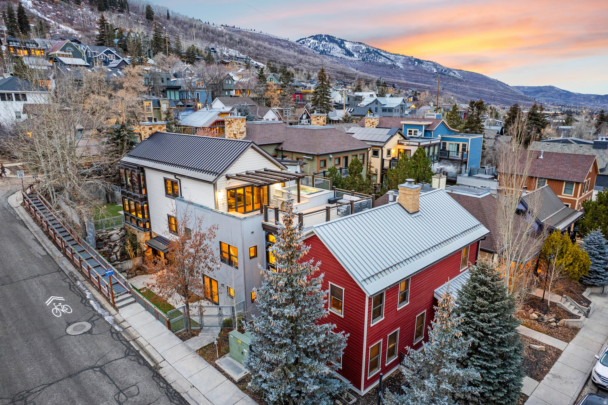 Iconic Ski-In/Ski-Out Legacy Estate at the Town Lift in Historic Old Town Park City  Welcome to Town Lift Haven, an iconic Park City luxury ski residence where Historic Old Town character, modern mountain design, and ski-in, ski-out access converge. Just steps from the Town Lift and Historic Main Street, world-class skiing, dining, nightlife, and Sundance venues are just outside your door. This unique listing includes 801 Park Avenue and 804 Woodside Avenue, two integrated historic residences held under separate tax IDs and sold together as one offering. Town Lift Haven lives as a refined estate designed for connection, celebration, and effortless mountain living. The rare dual-parcel structure offers long-term flexibility and investment value while functioning seamlessly as a single legacy property. Vaulted ceilings, exposed beams, and expansive windows frame sweeping mountain and town views. Contemporary finishes create an elevated retreat designed for hosting at scale, with accommodations for up to 28 guests across nine private ensuite bedrooms, multiple living areas, fireplaces, and media spaces. One of Old Town's most coveted rooftop decks overlooks Town Lift and Historic Main Street, while a fenced backyard sets the stage for aprs-ski gatherings and Sundance soires. The chef's kitchen features professional-grade appliances, complemented by a second full kitchen in the Red House for catered events or extended stays. A dedicated ski-prep room with boot dryers, ample storage, and direct Town Lift access streamlines every ski day. Wellness and accessibility are integrated with multiple steam showers, central elevator, and ADA-friendly design. Outdoors, a private fire pit and a rooftop terrace with hot tub, grill, and dining area offer a standout Old Town vantage point. Equally compelling as a primary retreat, generational gathering place, or high-performing luxury rental, Town Lift Haven is a rare opportunity in Historic Old Town, combining ski-in, ski-out living with architectural character, modern luxury, and enduring investment appeal.