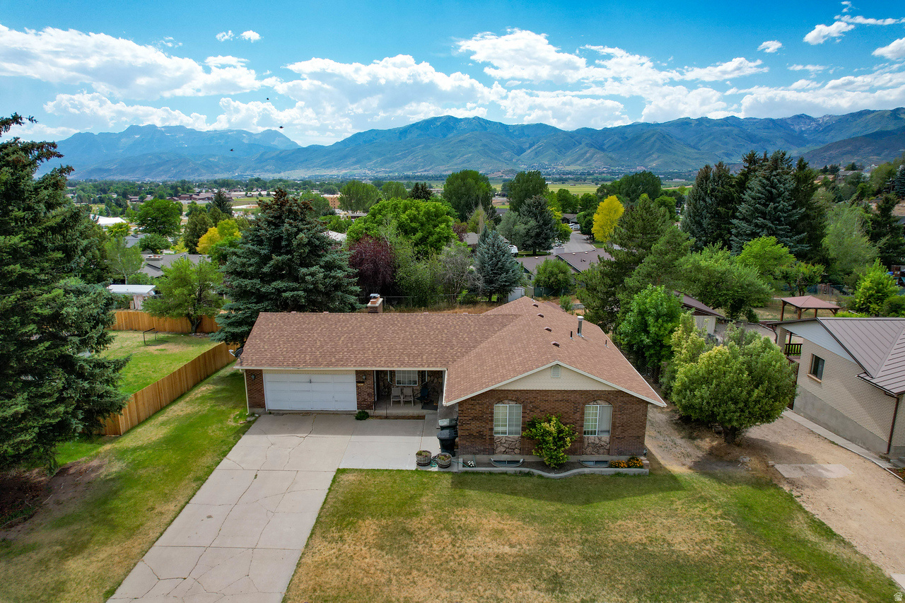 Welcome to your Heber Valley haven. Nestled on a generous 0.30-acre lot on the coveted Valley Hills Estates on the  north side of town, this 2,858 sq. ft. single-family home offers the perfect blend of mountain-valley living and exceptional potential. The inviting interior features a cozy gas fireplace, perfect for relaxing after a day exploring Utah's backyard playground or simply relaxing taking in the expansive mountain and valley views. Enjoy a massive yard with endless room to entertain, garden, or store your outdoor gear. Located just minutes from world-class skiing, local reservoirs, and top-rated Wasatch County Schools, this property is an incredible opportunity for homeowners and investors alike.