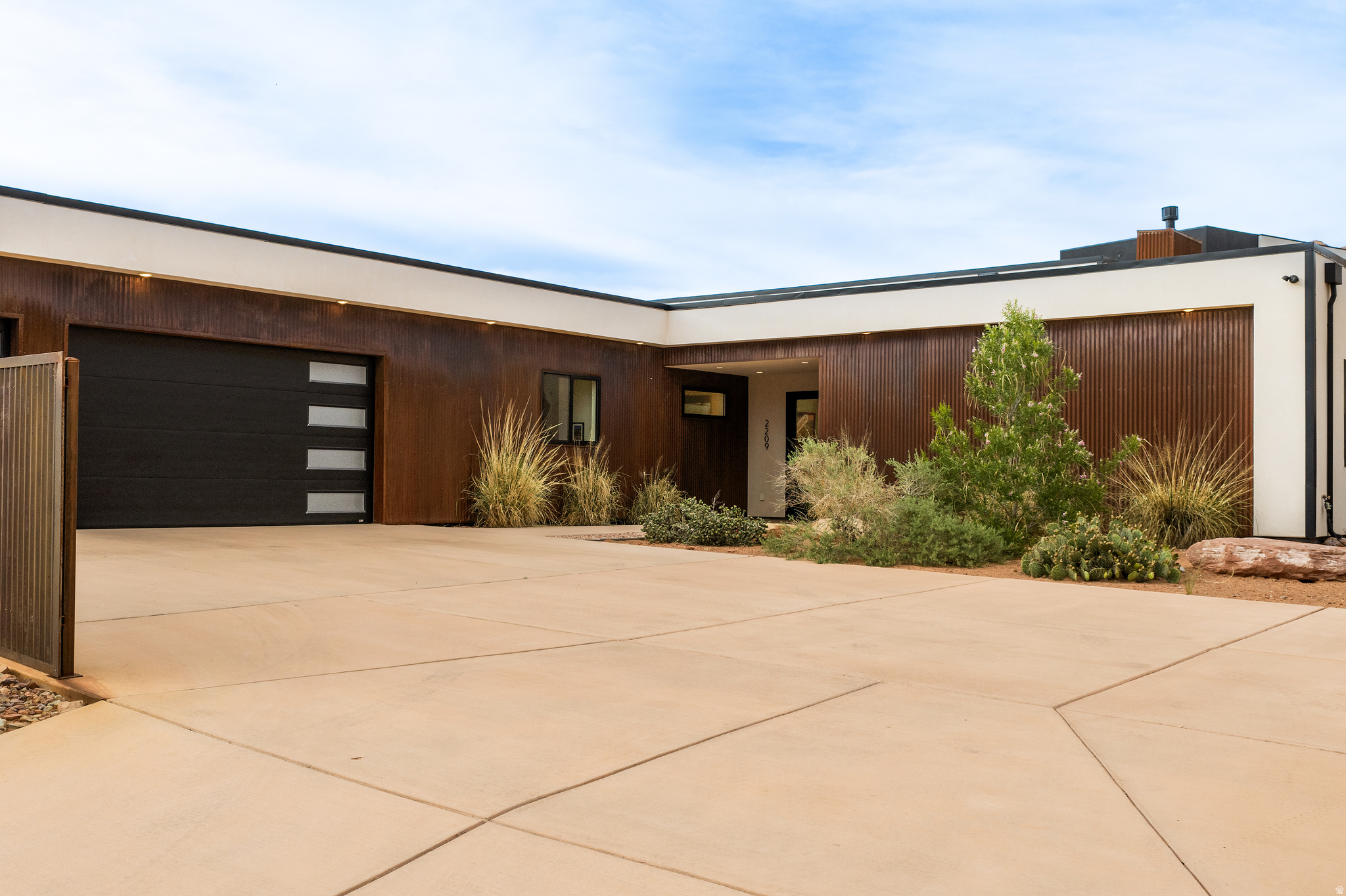 SLICK, MODERN COMFORT. Set under the iconic Matterhorn, this contemporary beauty was meticulously designed to appease the sophisticated eye. Simple, yet elegant with seamless integration into the red rock viewscape with exceptional outdoor space. Offered with the fine furnishings, you will have the ease of moving straight into comfort. Twelve-foot ceilings throughout help enhance the architectural position of the home for maximum benefit of views. This newly constructed luxury home with superior style and superior function celebrates two master en-suites, an additional guest bedroom and bath, office, as well as an outstanding mudroom with laundry. The generous living space beckons natural light with a formal dining room, open kitchen featuring custom welded metal work, quality stainless steel appliances, quartz countertops, and island seating. Both en-suites grant dual sinks, lavish showers with glass doors, and ample closet space. Concrete floors throughout compliment the crisp, clean lines of the home and help with ease of maintenance. Slide into the hot tub on one of the covered back patios to soak in the red rock splendor. The attached 3-car garage will assist with keeping your vehicles cared for, with additional parking on the oversized concrete driveway. This home is perfect for your recreational life and your love of linear design. Located near Moab's Golf Club, this marvel is within walking distance to hiking & golfing- as well as easy access to world-class OHV trails.