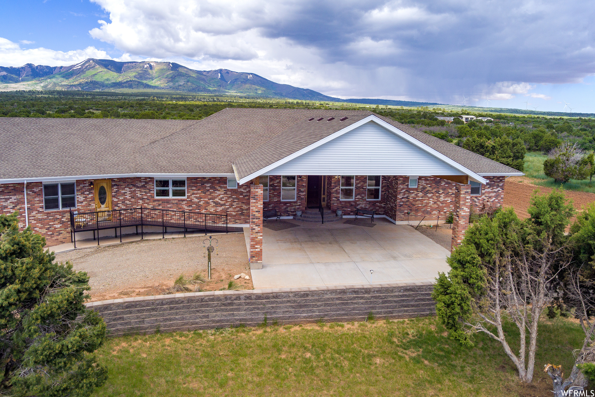 This stunning luxury home is located in the secluded Blue Mountains of Monticello, Utah surrounded by a vast 24.6 acres of private land, with breathtaking views of the Blue Mountains and the Colorado Mountain ranges to the east. There is an abundance of wildlife spottings including turkey, deer, mountain lion, elk, and bear. This property is just down the street from Lloyd's Lake with walking paths and picnic areas as well as beautiful campgrounds less than a mile up the mountain in the Manti-Lasal National Forest. This home will  welcome you like a hotel as you arrive under the portico to the front door. The foyer greeting is of mosaic tile and 1 of the 2 breathtaking imported chandeliers. The interior features an open floor plan with a spacious gourmet kitchen with granite countertops and bar seating for 8. There is also a large dining table under a massive 4 foot wide chandelier, and hickory floors throughout. The focal point of the open floor plan would be the brick pellet stove fireplace in the corner of the room in a step down conversation pit. The oversized master suite is a must-see including decorative wood cased french doors with etched glass  entering master suite. Master Suite includes a living room, marble shower, jetted tub, and a walk-in closet. Bedrooms 2 and 3 have a full bath and a laundry room between them. Pella windows with built-in blinds are throughout the home and mother-in-law apartment as well as custom lighting with master control, solid wood closet doors, wood stained baseboards and crown moldings. Some inclusions are the livingroom TV, entertainment center, leather couches and end tables.   Attached to the house with a separate wheelchair accessible entrance is an approximated 800 square foot mother-in-law apartment with a bedroom, a full bathroom, spacious living room, kitchenette, and a sleeping loft.  Outside the french doors leading to the backyard is a 600 square foot covered trex deck with views of the horsehead and the majestic Blue Mountains. The property also features a private well, septic tank, 2 furnaces, 2 A/C units and 2 RV hook-ups with additional power and septic. In the garage, there is a large access to the crawl space, an additional cooking stove for canning, large storage pantry, and a workbench. Additional brick is available matching the house that was intended for a security gate to enter the property. Home also includes 30,000 W grid-tied solar system installed in 2018.  The A1 Zoning does allow for nightly rentals, and the home would make an excellent base camp hunting lodge! There is 160 plus acres of additional land contiguous to the property available for purchase!  More hunting land for sale including 1100+ acres extending past Lloyd's Lake to Highway 191 and the Manti-LaSal National Forest, and 352 acres surrounding Lloyd's Lake.