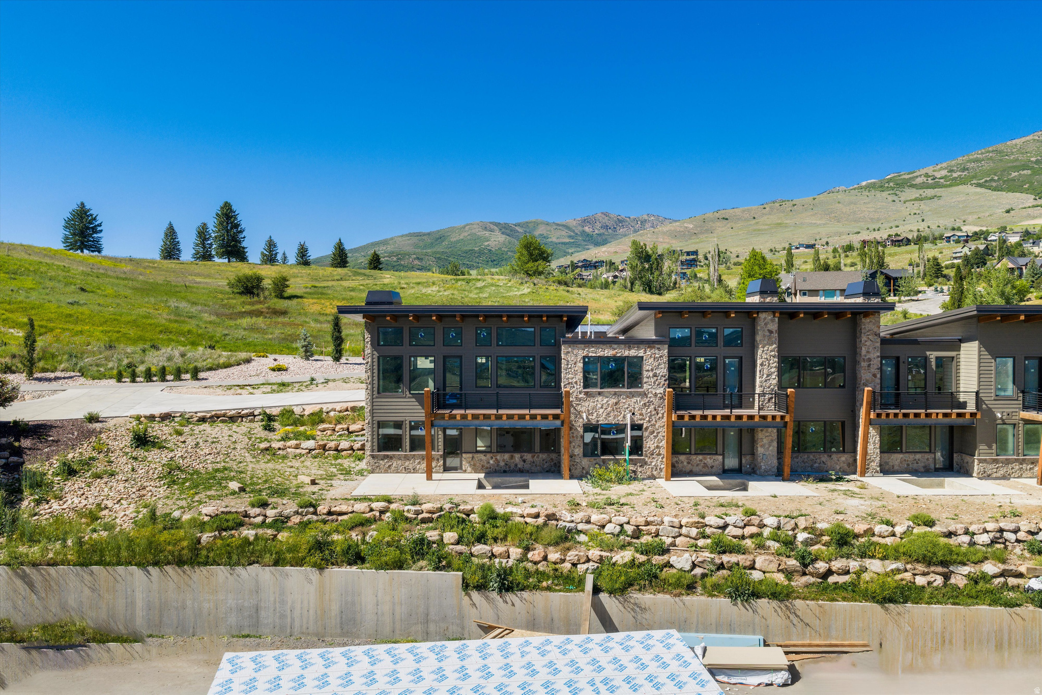 Experience refined mountain living in The Ridge at Wolf Creek Resort in Eden. This spacious end-unit Eureka Plan townhome offers 3,317 square feet with four bedrooms and three and a half baths, including a main level primary suite designed for easy everyday living. With zoning that allows short-term rentals, making it ideal as both a personal retreat and an investment property. As an end unit, the home benefits from additional windows that capture expansive valley and mountain views, while warm mountain finishes include knotty alder trim, doors, and baseboards, two stone fireplaces, and radiant heat on the lower level. An elevated deck extends the living space outdoors, and the two-car garage provides generous storage for gear in every season. Residents enjoy access to the completed community pool and hot tub with panoramic views, direct proximity to the public Wolf Creek golf course across the street, and endless nearby trails for hiking, biking, and year-round recreation. Square footage figures are provided as a courtesy estimate only. Buyer is advised to obtain an independent measurement.