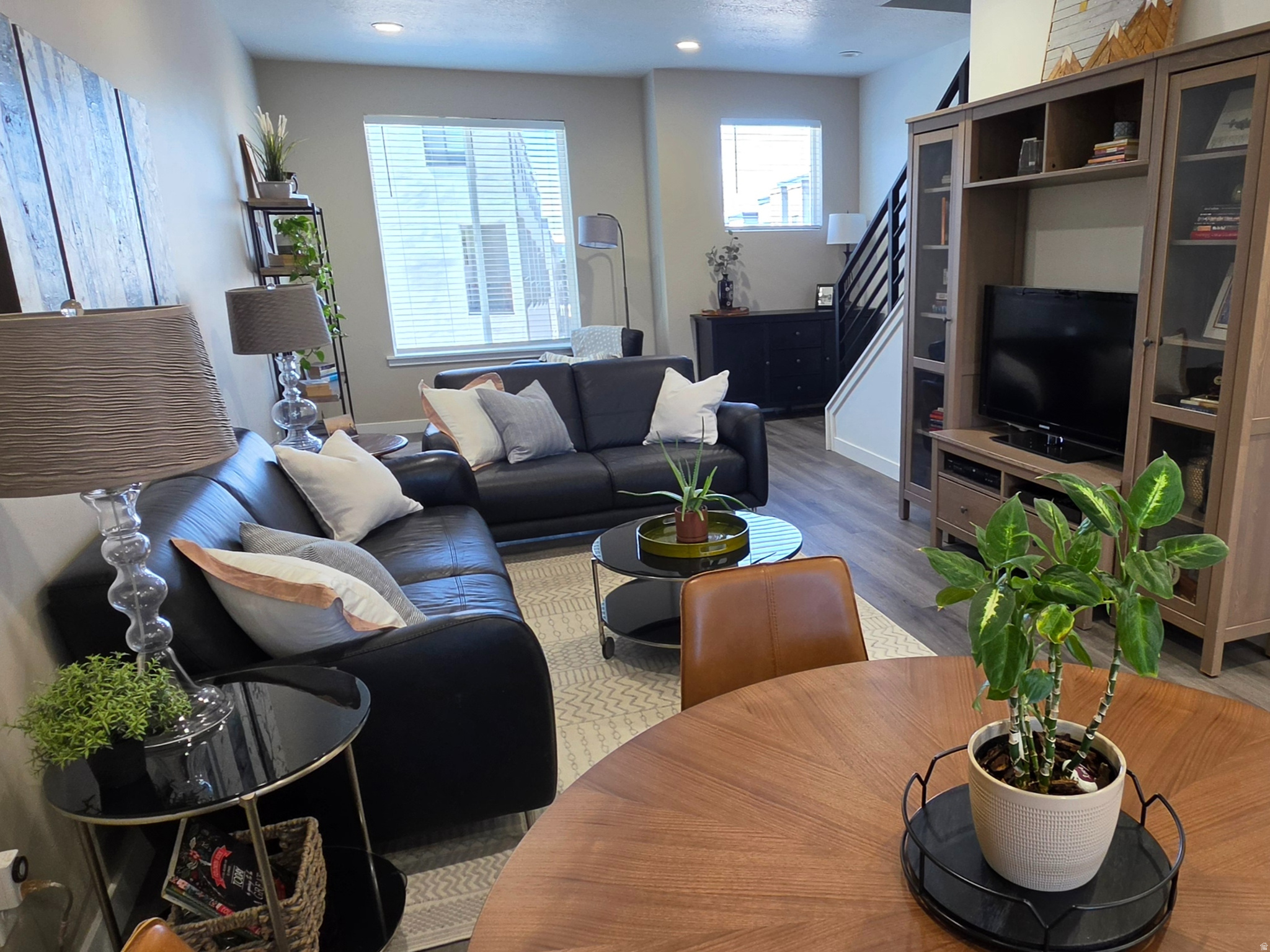 BETTER THAN NEW! Incredible Park Lofts Townhome in the heart of the newly developed North Salt Lake Town Center! Just minutes from the updated Town Hall, Police Station, and City Center, this property is completely turn-key and ready for you to move right in. Step inside this bright, light-filled open floor plan designed perfectly for both casual daily living and entertaining. The interior has been tastefully updated with custom designer paint, creating an inviting and modern atmosphere. The gourmet kitchen is a chef's delight, featuring pristine white cabinetry, gleaming quartz countertops, stainless steel appliances-including a gas range and refrigerator-and a massive walk-in pantry. Modern iron stair railings and a convenient guest powder room accent the open main living area. Step out onto your private balcony to relax and overlook a quiet, tree-lined cul-de-sac. As a rare and special bonus, this home is perfectly situated to offer stunning mountain views out of every window. Upstairs, the layout is designed for maximum privacy and comfort, offering two spacious bedrooms, each with a private en-suite bathroom and a generous walk-in closet. The primary bath includes double sinks and a large walk-in shower. The washer and dryer are conveniently located right on the bedroom level. Downstairs, you will be pleasantly surprised by the large tandem 2-car garage, which offers ample room for vehicles, extra storage, and dedicated space for trash containers inside. From there, you can walk out to your own fully fenced, private backyard space. The beautifully maintained community common areas include a fenced half-court basketball court, covered picnic areas, a pergola, and a dedicated fenced dog park. Best of all, the massive $20 Million Hatch Park Redesign and Redevelopment project is underway right across the street! This convenient location offers an unbeatable commute: just 8 minutes to downtown Salt Lake City and 10 minutes to the airport. You are also only minutes away from several incredible hiking and mountain biking trails, as well as outstanding public golf courses. Quiet, friendly, and perfectly located-this community is an absolute pleasure to live in.--