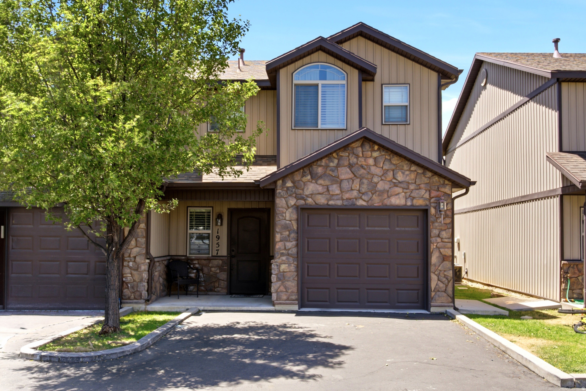 This beautifully remodeled 3-bedroom, 2.5-bath townhome offers the perfect blend of comfort, convenience, and lifestyle. Move-in ready with quartz countertops, upgraded carpet,  top of the line primary bathroom, and a cozy gas fireplace. The home features a soft light gray color palette and abundant natural light that creates a bright, inviting atmosphere throughout. Enjoy low-maintenance living with HOA maintained landscaping, giving you more time to relax and enjoy your home. Step outside to a large open grassy area and playground like it's your own park-like backyard. Perfect for outdoor fun or keeping an eye on little ones from the kitchen or dining area. The extra-deep detached garage includes built-in shelving and is pre-wired for electric vehicle charging, offering exceptional storage and convenience. Start making memories here!