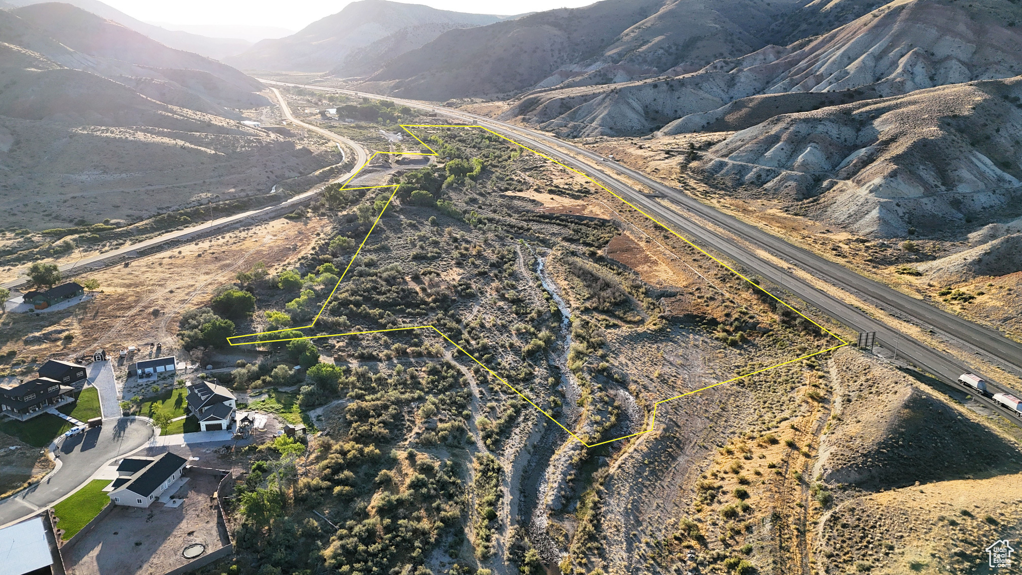 Located just outside the city limits of Salina, Utah, this property combines development potential with natural features and convenient access to both town and recreational opportunities. Positioned between the city park and the city fish pond, the land sits in a location that balances quiet surroundings with quick proximity to community amenities. The parcel has frontage along Old Highway 10, providing paved road access and power availability at the property's edge. Interstate 70 forms the southern boundary, enhancing accessibility while keeping the land situated near key routes in central Utah. Salina Creek flows through the property for more than half a mile, offering year-round water and supporting a corridor of mature trees. The creek provides a natural landscape feature, with wildlife including deer, turkeys, fish, and the occasional beaver observed in the area. Several acres of the land have already been cleared and leveled, offering building-ready ground for homesites or other uses. The property includes more than 4 acre-feet of underground water rights, supporting multiple residential possibilities. This water resource enhances the flexibility of the land, whether for a private residence, multiple homesites, or future development. Within walking distance, the Salina city park complex and fish pond provide convenient recreation. Services, including groceries, fuel, restaurants, and the post office, are only a short drive away. At the same time, the property lies less than two miles from the boundary of Fishlake National Forest. The area offers access to the Piute ATV Trail system, Gooseberry Campground, and the Great Western Trail, making it an ideal location for those who value outdoor recreation alongside town access. The property's elevation averages 5,270 feet, with a mix of cleared building sites, creekside tree cover, and views of surrounding mountain ranges. The location places it in the center of Utah, with quick connections to both local resources and regional recreation. Salina is the closest community, offering essential services within minutes. Richfield, approximately 20 miles to the southwest, provides expanded shopping, healthcare, and schools. Provo lies about 90 miles north, while Salt Lake City is about 140 miles from the property. This parcel presents opportunities for development or personal use, combining natural features like Salina Creek and mature trees with water rights and infrastructure access. Its balance of location, resources, and recreational opportunities makes it a distinctive option for buyers seeking land in central Utah.