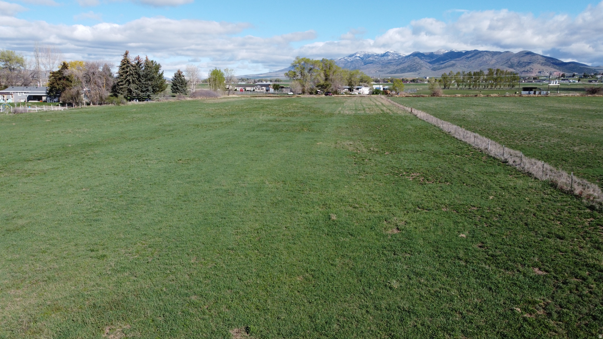 4.73 Acres  Prime Residential Land in Malad City, Idaho  Discover the perfect setting for your dream home on this beautiful 4.73-acre parcel located just outside the city limits of Malad. Situated on Samaria Lane, this residentially zoned property offers privacy, space, and flexibility - ideal for a private estate or potential division into two single-family dwellings (buyer to verify division potential with Planning & Zoning).  Enjoy stunning, panoramic views of the surrounding Malad Valley, offering wide-open skies and picturesque mountain backdrops in every direction.  The land includes valuable groundwater rights with beneficial use designated for irrigation. Currently planted in alfalfa, the property is fully fenced and ready for continued agricultural use, livestock, or future development.  Experience peaceful rural living with convenient access to town amenities. Whether you're looking to build your custom home, create a small homestead, or invest in development potential, this property offers outstanding opportunity in a highly desirable location.