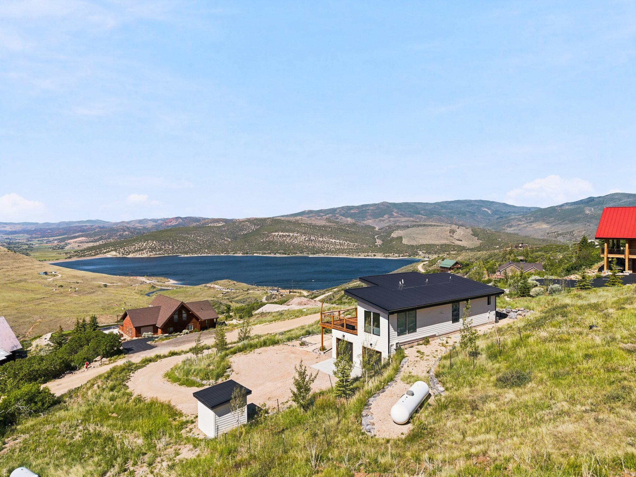 Tucked into the mountains above Rockport Reservoir, this exceptional modern mountain retreat offers the perfect balance of privacy, recreation, and accessibility. Surrounded by breathtaking views in every direction, you'll experience the peace and tranquility of mountain living while remaining within easy reach of Park City, Salt Lake City International Airport, and major transportation corridors.  Designed to embrace its incredible setting, the home features expansive windows that frame the surrounding mountains and bring natural light into every living space. The thoughtfully designed interior showcases an upgraded kitchen, high-end appliances, and modern finishes throughout, creating a home that is equally suited for everyday living, entertaining, or weekend escapes.  Outdoor enthusiasts will appreciate being minutes from world-class recreation, including hiking, mountain biking, trail running, boating, fishing, skiing, and countless opportunities to explore Utah's incredible mountain landscape. Spend your mornings watching the sun rise over the mountains, your afternoons on nearby trails or at the reservoir, and your evenings enjoying the quiet solitude that only mountain living can provide.  Properties that combine this level of privacy, scenery, recreation, and convenience are increasingly difficult to find. Whether you're looking for a full-time residence, mountain getaway, or investment opportunity, this is a rare chance to own a truly special piece of Utah's mountain lifestyle.