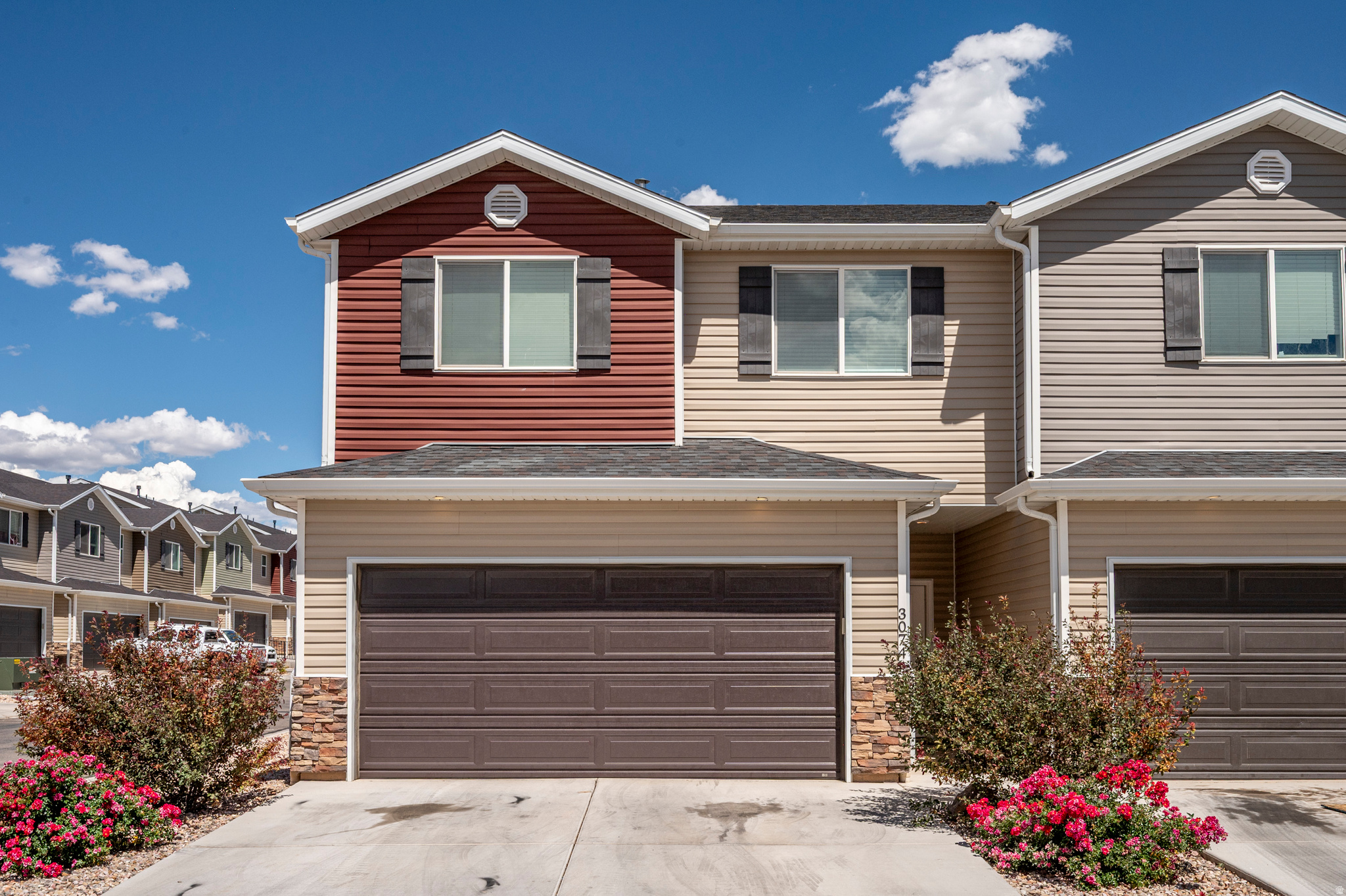 Welcome to this beautifully designed townhome featuring 3 bedrooms and 2.5 bathrooms. The attached two-car garage offers ample storage. Inside, you'll enjoy 9-foot ceilings on the main level, creating an open and inviting atmosphere. The main living space is accented with durable luxury vinyl plank flooring, while plush carpet adds comfort to the bedrooms and upstairs hallways. The kitchen boasts stainless steel appliances, a gas range, quartz countertops, a stylish subway tile backsplash, and soft-close cabinets. The cozy living room features a charming shiplap accent wall and beautiful lighting fixtures. The master bathroom includes his and her sinks for added convenience. Step outside to a fenced backyard and covered patio, ideal for outdoor gatherings and relaxation.