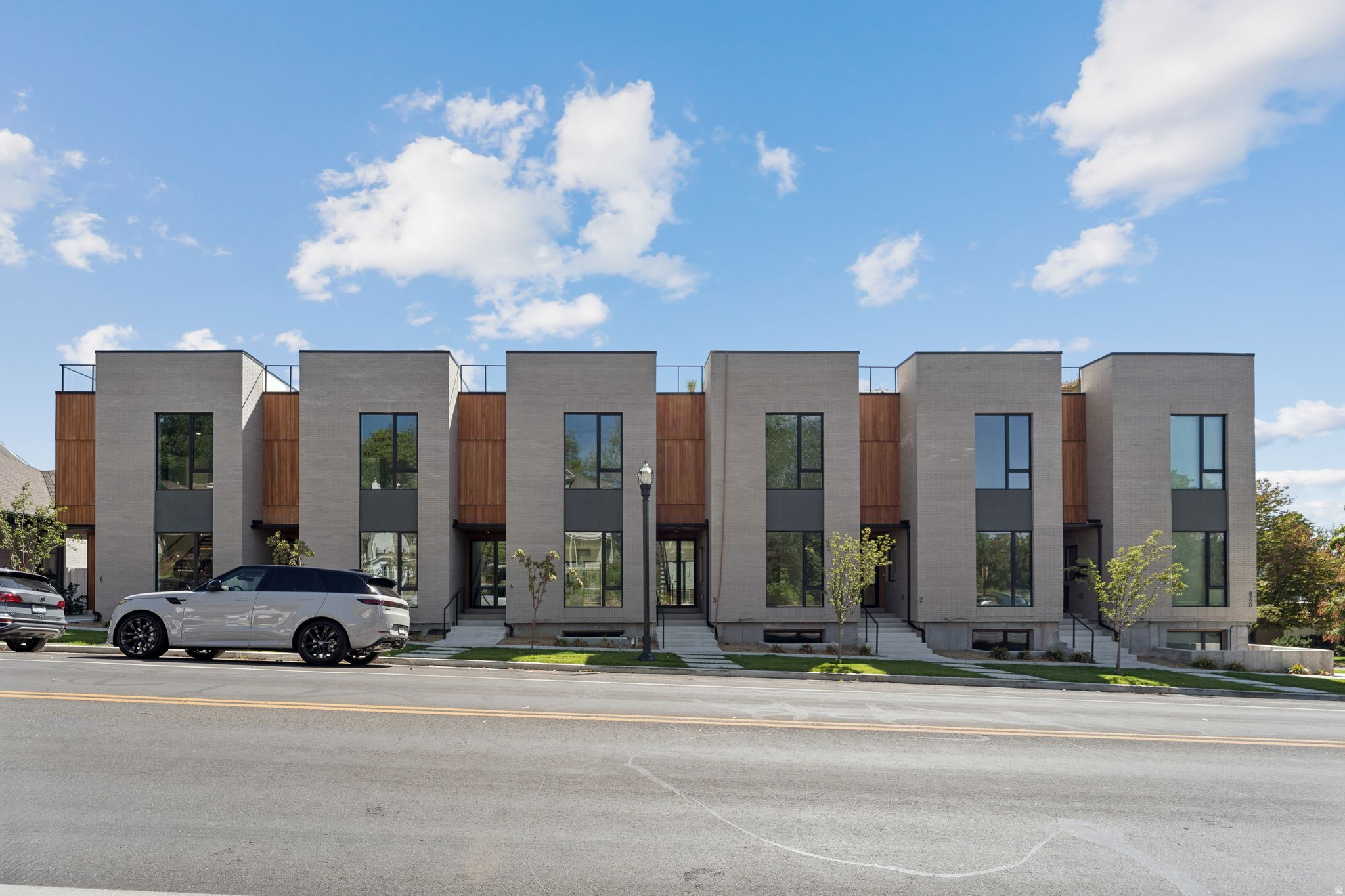 Prime Avenues townhomes are now available! These stunning modern residences offer some of the finest townhome living in North Salt Lake City, just minutes from downtown Salt Lake City, the University of Utah, shopping, dining, and entertainment. Designed with both style and comfort in mind, each home features open-concept living, hardwood floors, oversized custom windows that flood the home with natural light, high-end Monogram appliances, and a waterfall kitchen island. Additional upgrades include custom black windows, floating staircases, bathrooms on every level, humidified furnaces, Google Fiber and Xfinity connectivity, and an oversized two-car garage with glass doors and epoxy floors large enough for full-size trucks. The luxurious spa-like primary suite offers a true retreat, while the private rooftop deck-over 1,000 square feet and engineered to support a hot tub-delivers breathtaking panoramic views of the Wasatch Mountains, downtown Salt Lake City, the State Capitol, gorgeous sunsets, and the University of Utah. This is an entertainer's dream home, designed to be admired by all, offering modern design and an unbeatable Avenues location.