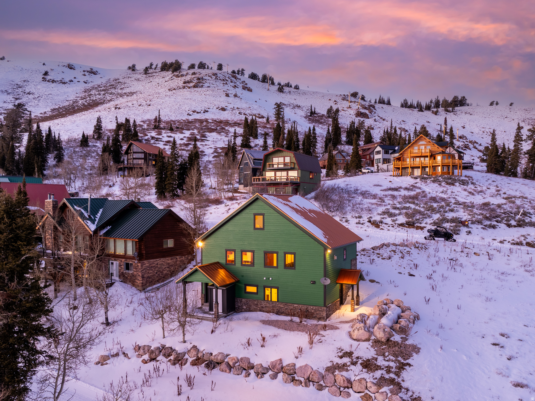 Aspire to do life in this vortex - where adventure, community, and alpine beauty meet at Powder Mountain. Discover mountain living at its finest in this stunning 4-bedroom, 5-bath retreat located on world-renowned Powder Mountain. Offering true ski-in, ski-out access, this home provides unmatched convenience for outdoor enthusiasts looking to hit the slopes at a moment's notice. After an exhilarating day of skiing, relax and unwind in the aprs-ski sauna, completing your perfect mountain experience. Thoughtfully designed to capture panoramic alpine views, this home blends modern comfort with rustic elegance. The windows, while not expansive, are purposefully sized to maximize energy efficiency and preserve the view plane, offering just the right balance of natural light and privacy. A spacious downstairs studio offers flexibility for guests, a home office, or a quiet retreat. The main living areas are brightened by abundant light while maintaining a cozy, intimate atmosphere. The stone fireplace in the great room provides a warm and inviting space for family and friends to gather after a day in the mountains. The functional kitchen flows seamlessly into the dining and living areas, offering ample storage and workspace for cooking and entertaining. The primary suite is a true sanctuary, featuring sweeping mountain vistas and a luxurious, spa-inspired bathroom. Multiple living spaces ensure there's always a spot to relax, work remotely, or host loved ones. With direct access to world-class skiing, hiking, biking, and year-round mountain adventure right outside your door, this home offers unparalleled access to all that Powder Mountain has to offer. Additional highlights include durable flooring, generous gear storage, thoughtful lighting, and an inviting mountain-lodge feel. Whether you're seeking a full-time residence or a luxurious alpine getaway, this beautifully constructed home delivers comfort, style, and a prime location at the resort. All property information, boundaries and documents to be verified by buyer.