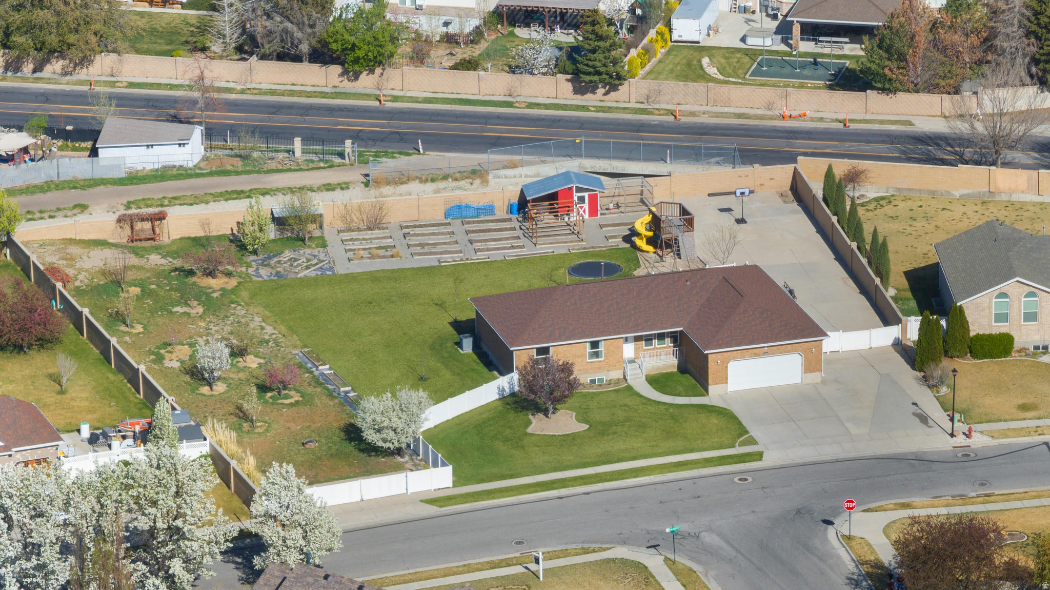 Contact owner Ryan Campbell for showings 385-351-5487**Rare .71-Acre Homestead - Fully Remodeled - No HOA  Experience the perfect blend of modern luxury and self-sufficient living in this meticulously updated 7-bedroom, 5-bathroom South Jordan estate. Situated on nearly 3/4 of an acre with full animal rights and rare secondary water ($19/mo), this property is a "unicorn" for toy owners, gardeners, and those seeking space without compromise.  Interior Highlights: - Gourmet Kitchen (2023): Completely remodeled with custom oak cabinetry, high-end granite, double ovens, and a gas stove. - Turn-key Finishes: Brand-new LVP and carpet throughout (2026), updated plumbing fixtures, and fresh paint. - Mechanical Peace of Mind: New Roof (2021), High-Efficiency Windows (2022), SpringWell Whole-House Filtration (May 2024), and New Water Heater (March 2026).  Outdoor & Hobbyist Paradise: - Massive Storage: 185-foot concrete pad with dual 15-foot gates; fits 3+ trailers side-by-side. - The Orchard & Garden: 12 producing fruit trees and 28 grow boxes with automated irrigation. - Smart Home: 16-zone Rachio smart watering system and Nest thermostat. - Included Extras: 2019 Poulan PRO Riding Mower, custom secure 20-chicken coop, in-ground trampoline, and a massive playhouse. - Spa Ready: Dedicated 220V electrical hookup and cement pad ready for your hot tub.  No HOA. Ideally located near top-rated schools and shopping while maintaining a private, rural feel.  Square footage figures are provided as a courtesy estimate only and were obtained from county records.  Buyer is advised to obtain an independent measurement.