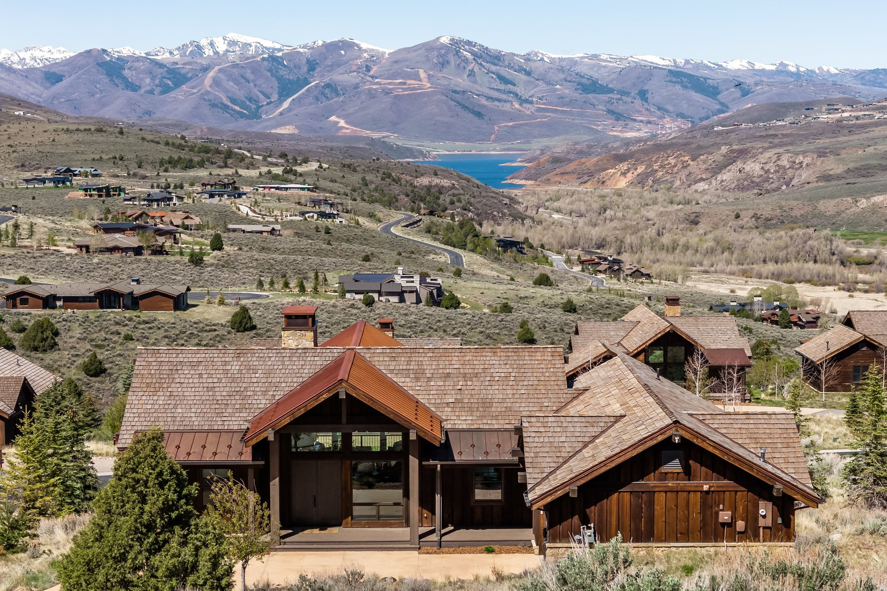 This mountain retreat is the best of the best.  A straight on view of Deer Valley, the Jordanelle Reservoir, and the Rees Jones Golf Course offering the premier view at Victory Ranch. Inside, living spaces are open and welcoming.  Enhanced by soaring vaulted ceilings, a wood burning fireplace, Du chateau flooring, automated shades, new light fixtures and furniture, and designer finishes. On the main level a chef's kitchen features open shelving and full-height classic shaker cabinetry, and the expansive great room perfect for entertaining. Each bedroom includes an en-suite or designated bath, providing comfort and privacy for family and guests alike. A luxurious main floor King Suite bedroom provides retreat-like comfort.  The walk-out lower-level includes 3 bedrooms, 3 baths, and a family room with gas fireplace. Outdoor living is elevated with spacious decks, patios and firepit, designed to capture both sunrise and sunset.  You'll enjoy immediate access to world-class amenities including fine dining, state-of-the-art fitness facilities, 2 pools, and year-round events. This premier community also offers a championship golf course, private fly fishing on the Provo River, and access to over 3,500 acres of pristine backcountry for hiking, biking, and exploring. Whether you're savoring a quiet morning on the deck or heading out for an adventure, this is mountain living at its finest.  Victory Ranch is a private, four-season community amidst 6,250 pristine acres along four miles of the Upper Provo River. Amenities include an 18-hole Rees Jones golf course, freestone river fly fishing, upland bird hunting, 30+ miles of mountain biking and hiking trails, 5-stand shooting facility, archery range, 4x4 adventures, snowmobiles, kids zip-line, backcountry yurts, fishing ponds, multiple restaurants, shuttles to Deer Valley & Park City, a ski-in/ski-out lodge in Park City, and more than 3,500 acres of untouched backcountry. The Post Clubhouse includes our concierge team, heated pool, hot tubs, lounge, and coffee/ice cream bar. The Barn features a fitness center, spa, general store, pizza and ice cream parlor, art studio, game room, indoor basketball/sport court, tennis, paddle, and pickle courts, swimming pool with food and beverage service, event lawn and will be sure to provide hours of family fun. Victory Ranch is less than an hour from Salt Lake airport, approximately 15 minutes from Deer Valley and 25 minutes from Park City.