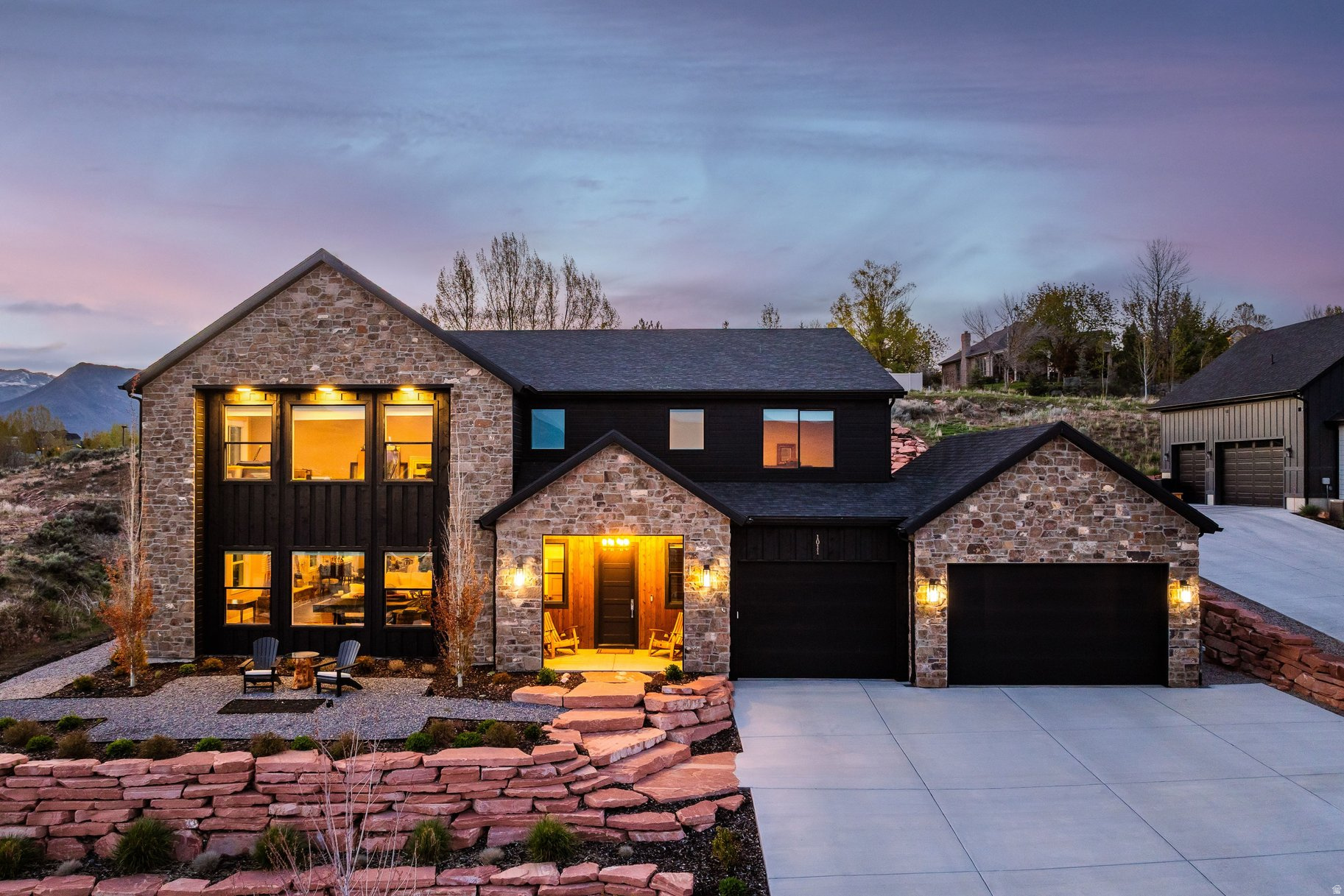 Mountain and lake views paired with high-end upgrades make this home stand out! Situated on a .35-acre lot, this home offers an open layout with 10-foot ceilings and a great room centered around a stone fireplace. The expanded kitchen-with two large islands, custom cabinetry, integrated LED lighting, dual dishwashers, and high-end GE Monogram and SubZero appliances, plus wine and beverage coolers-makes this home ideal for entertaining. LVP flooring runs throughout, complemented by a modern glass and steel staircase and a CUBE pneumatic vacuum elevator for easy access upstairs. The upper-level library or office, complete with a fireplace, custom shelving, and sliding glass doors, will quickly become your favorite room in the house. The primary suite captures Mount Timpanogos views and includes a stacked washer and dryer. Bathrooms are updated with walk-in showers and frameless glass. Additional features include whole-house water filtration, radon mitigation, an owned security system, and a 3-car garage with epoxy floors, heater, and EV charging. Exterior upgrades include fresh paint, sealed concrete, and custom cedar fencing. Minutes to Deer Valley East Village, Park City, and Sundance-this is a rare opportunity to own a thoughtfully upgraded home with views, design, and location all in one.