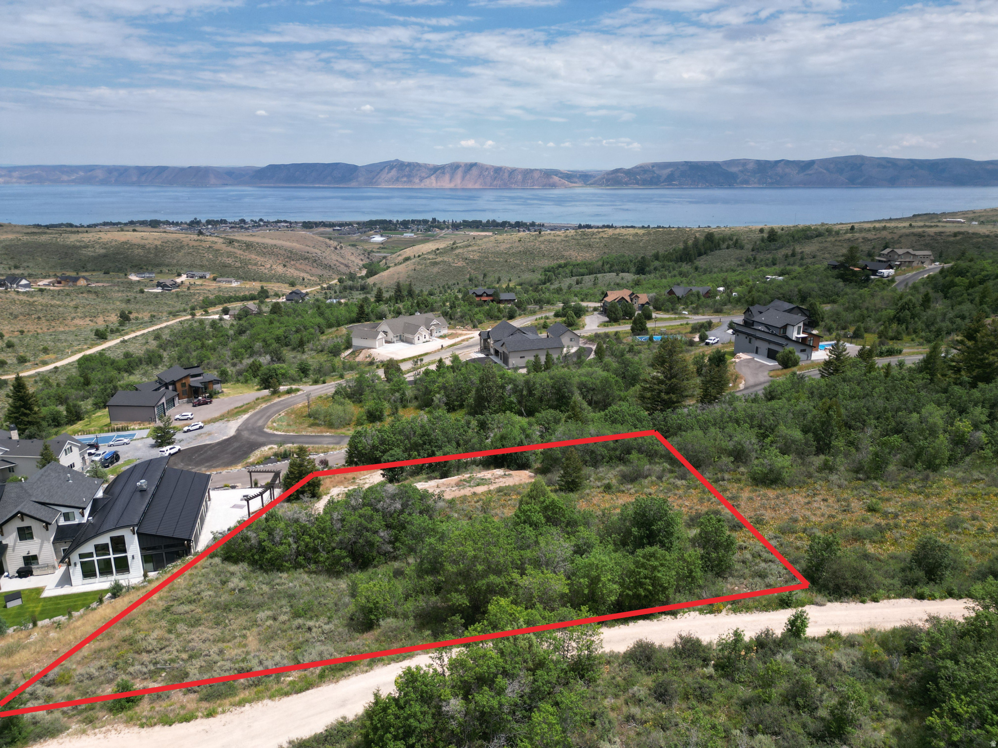 .98-acre lot located in the desirable Eagle Feather Shundahai is the perfect canvas for your dream home or investment property. Perched in a peaceful setting, this lot offers breathtaking views of Bear Lake and the surrounding mountain ranges while being surrounded by trees for that true lake mountain feel, creating a truly picturesque backdrop for your future build. With nearly a full acre of land, you'll have plenty of space and flexibility to design a custom home, cabin, or income-generating property tailored to your vision. Paved roads make for easy year round access. Whether you're looking for a serene retreat or a long-term investment. Enjoy easy access to outdoor recreation, including boating, hiking, ATV trails, and world-class winter activities-all just a short drive away. Don't miss your chance to own a piece of Bear Lake paradise in Eagle Feather Shundahai!