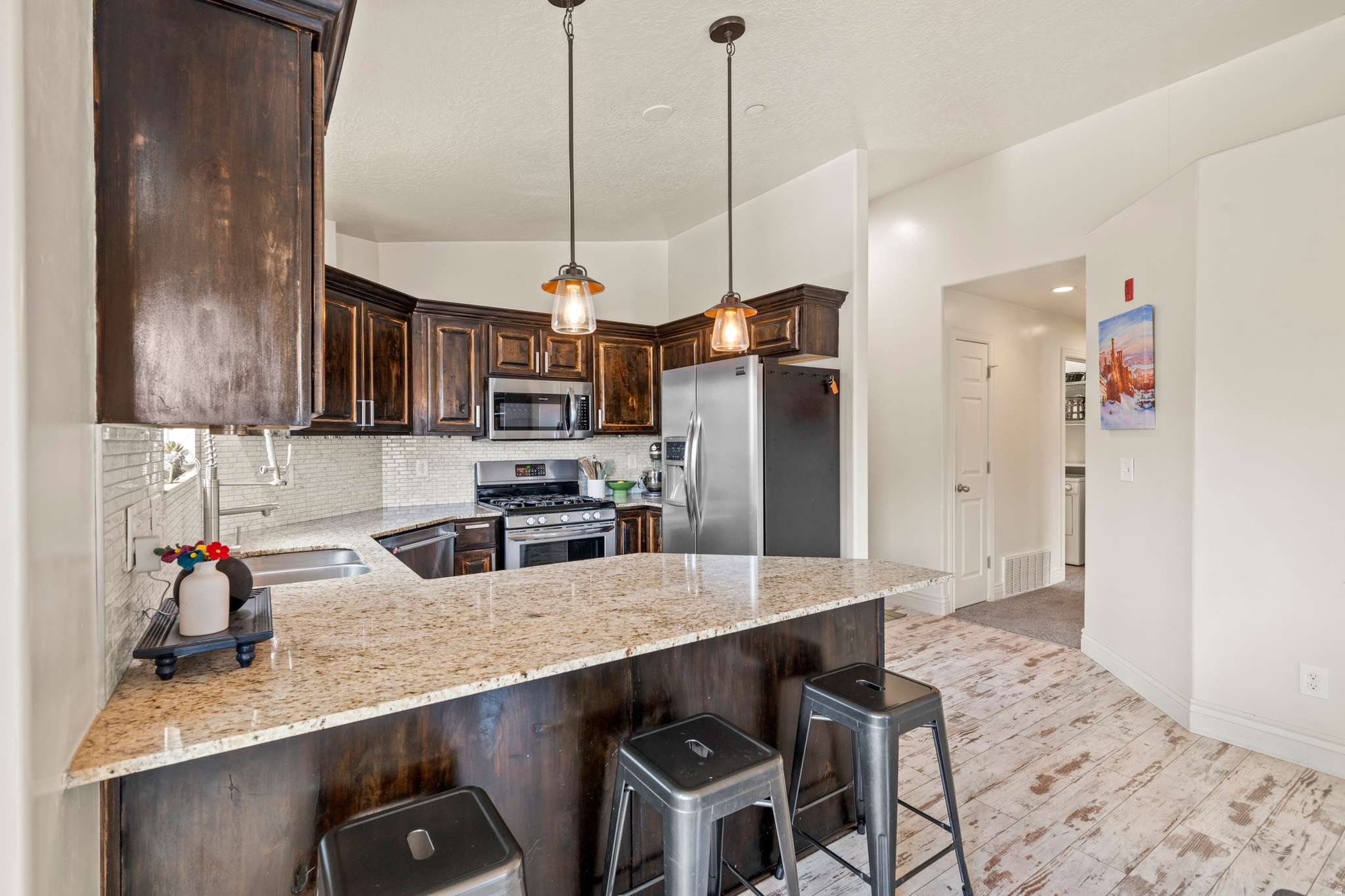 Welcome to elevated living at East Town Village. Perched on the top floor, this bright corner condo showcases breathtaking views of the Wasatch Mountains and offers the perfect blend of comfort, style, and convenience.The open-concept layout is filled with natural light and features vaulted ceilings, a spacious living area, and a chef-inspired kitchen designed for both everyday living and entertaining. The generously- sized primary suite easily accommodates a king-size bed with additional space for furnishings, creating a true private retreat. The primary bathroom features elegant marble finishes, a beautifully designed shower, and a spacious walk-in closet.Two additional bedrooms provide exceptional flexibility for guests, a home office, fitness space, or extra storage. Residents enjoy access to community amenities including a clubhouse, pool, and spa. Conveniently located near world-class skiing and hiking in nearby canyons, with easy access to interstates, transit routes. Minutes from theaters, restaurants, shopping, and America First Stadium.