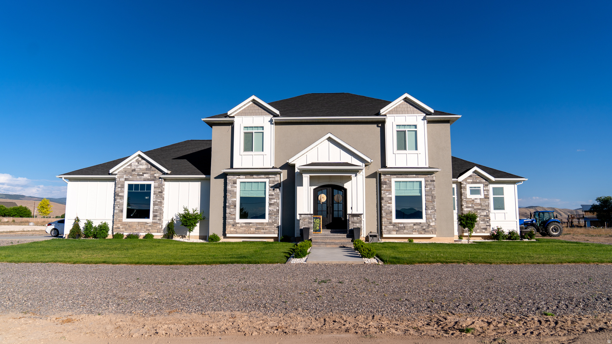 Welcome to your dream home in the peaceful community of Axtell, Utah! This stunning newer construction sits on over an acre and offers the perfect blend of luxury, comfort, and modern convenience.  Featuring 6 spacious bedrooms and 5 beautifully appointed bathrooms, this home provides plenty of space for family, guests, and entertaining. The thoughtfully designed floor plan showcases an incredible gourmet kitchen complete with top-of-the-line appliances, abundant counter space, a large island with a built-in ice maker, and a spacious walk-in pantry with a convenient grocery door.  The open-concept living and dining areas create the perfect setting for everyday living and memorable gatherings. Downstairs, you'll find a dedicated home gym to support an active lifestyle and a private theater room that's perfect for movie nights with family and friends.  Step outside and enjoy the expansive acreage with endless possibilities for recreation, gardening, animals, or simply taking in the breathtaking rural surroundings. Adding to the home's exceptional curb appeal are professionally installed Trimlight permanent exterior lights, allowing you to celebrate holidays, special occasions, game days, or create custom ambiance year-round with the touch of a button.  This remarkable property offers the space, amenities, and lifestyle you've been dreaming of. Don't miss your opportunity to own this incredible Axtell retreat-schedule your private showing today!