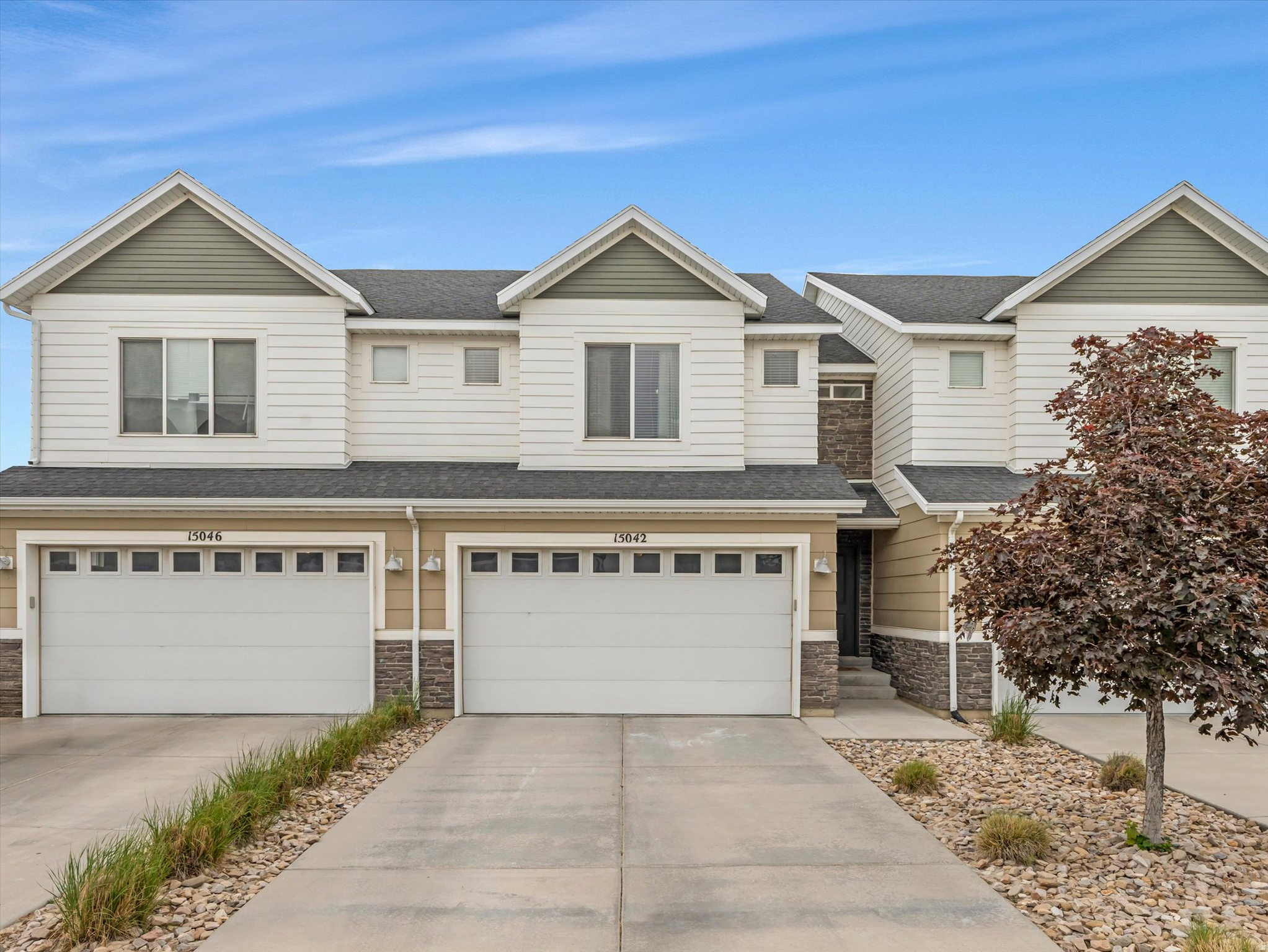 Beautiful townhome located in the perfectly situated, Independence at the Point community. This master planned neighborhood offers an incredible lifestyle with multiple parks, scenic walking and biking trails, a community garden, and quick freeway access for an easy commute anywhere in the valley. The community garden is just steps from the home, and nearby trails provide convenient access to Mount Jordan Park, Independence Park, and the new Day Ranch Park. Enjoy endless outdoor amenities including playgrounds, splash pads, a skate park, pickleball courts, and more. Inside, the open concept main level features a stylish white kitchen with stainless steel appliances and a gas range. All appliances are included, and the refrigerator, dishwasher, and disposal have all been replaced within the past three years. The comfortable living room is the perfect place to relax while taking in beautiful valley views. The dining area offers plenty of space for gatherings, and the generous pantry provides excellent storage. Step outside to the deck and the yard below and enjoy the open backyard that flows directly into common space, giving you extra room to play, entertain, or unwind. Upstairs features an extra-large bedroom with a walk-in closet, a spacious guest bedroom, and a huge owner's suite complete with dual walk-in closets. The conveniently located upstairs laundry room means no hauling laundry up and down stairs and the newer washer and dryer are included. The light filled daylight basement offers a huge family/game room with abundant storage space and a convenient powder bath, making it the perfect flex space for entertaining, hobbies, or relaxing. Additional highlights include a two-car garage, extra driveway parking, a kwickset smart lock for the front door and best of all, a location that combines comfort, convenience, and access to outstanding community amenities.