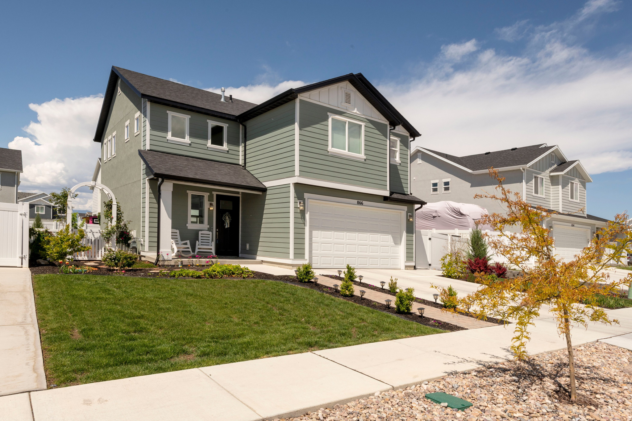 Tucked away in the highly sought-after Stonecreek community of American Fork, this beautiful custom two-story home showcases exceptional curb appeal and pride of ownership from front to back. A charming brick-paver path leads to the welcoming front porch with stunning views of the Wasatch Mountains. Inside, a grand staircase and soaring two-story ceilings create an impressive entry. The open-concept main floor is flooded with natural light, upgraded LVP flooring, and stylish two-tone paint throughout. The eat-in kitchen offers a center island, GE stainless steel appliances, abundant cabinetry, generous counter space, and an incredible walk-in pantry. The family and kitchen area flow seamlessly to the outdoors through sliding glass doors to the backyard patio and BBQ area, perfect for entertaining. Upstairs offers functional built-ins, a spacious primary suite with vaulted ceilings, a walk-in closet, and a spa-like bath with a separate soaking tub and shower. Two additional bedrooms, a full bath, and a large laundry room complete the upper level. The meticulously maintained yard has been transformed into a garden paradise complete with a trellis archway. Everything from annuals, perennials, rose and berry bushes, fruit trees, herb garden and raised garden beds. Walking distance to the neighborhood park and playground. Highly rated schools, nearby dining, entertainment, and shopping, plus convenient freeway access and FrontRunner commuting.