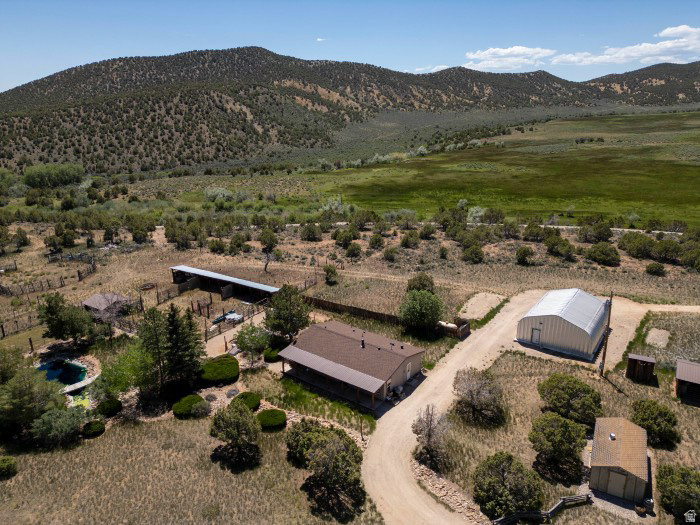 Escape the city to this secluded 39.24-acre equestrian in Deep Creek. This property features a 3-bed, 2-bath home and an expansive 6-car detached garage/shop. Perfect for outdoor enthusiasts, this estate combines country privacy with incredible Uintah Basin mountain and valley views. Possible second home on property.