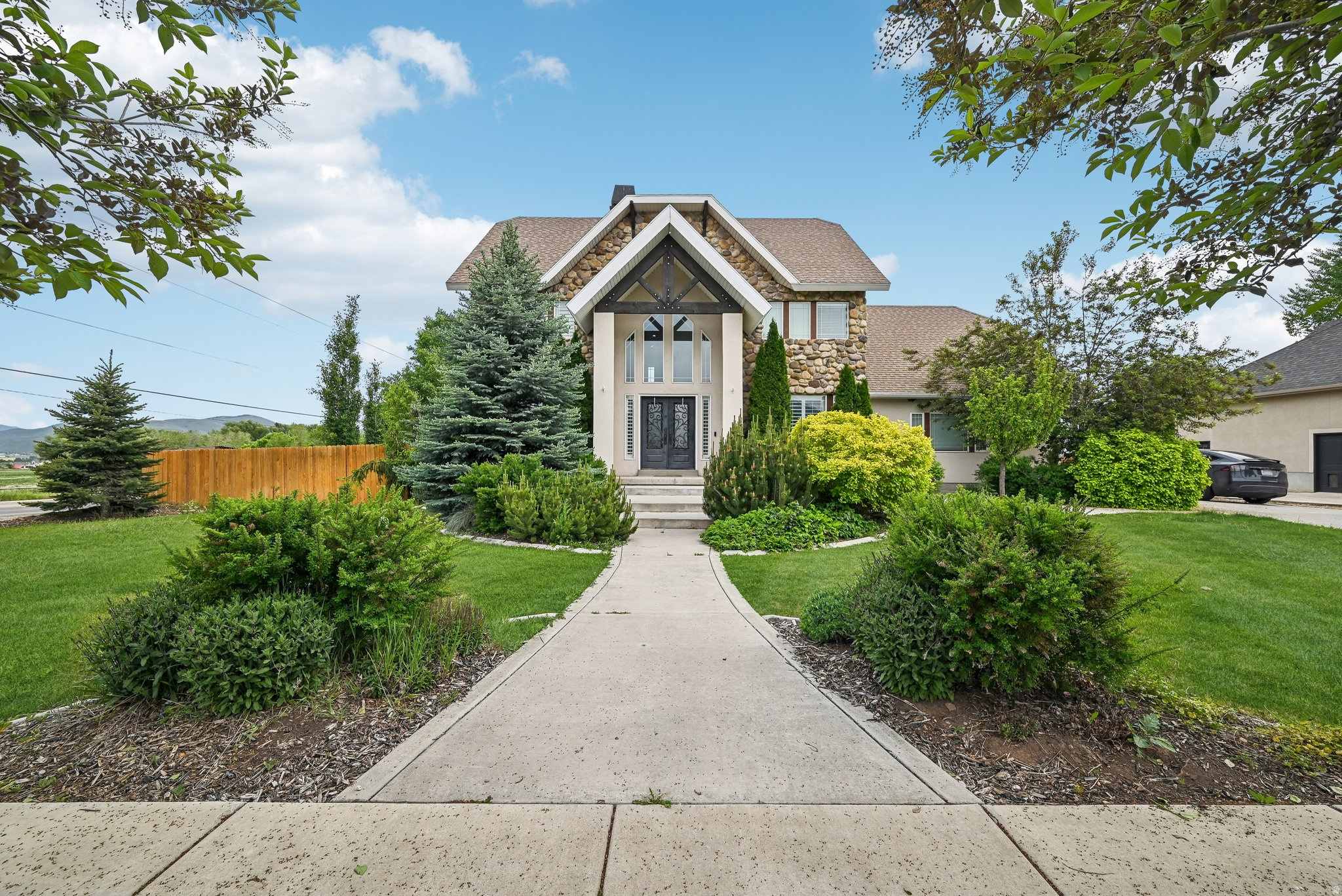 Spacious and well-located in the heart of Midway Valley, this 5-bedroom, 3.5-bath home offers  a functional floor plan across its three levels with generous living spaces all on an incredible corner lot.   The main level features soaring ceilings and expansive windows that fill the living room with natural light, a dedicated home office, powder bath, and a semi-formal dining area that flows seamlessly to both the kitchen and also the back deck, patio, and large fenced backyard. The kitchen is well equipped with plenty of cabinet storage, usable counter space, and ample room to move about. A laundry and mudroom complement this space, leading out to the attached two-car garage, which includes an EV charger.   Upstairs, you'll find three bedrooms, including the spacious primary suite with a large closet and ensuite bath, along with an open loft overlooking the living room and leading to a private balcony deck overlooking the backyard. The fully finished lower level expands the home's versatility and convenience with a large family room, two additional bedrooms, closets, and a full bath.   Situated on a desirable corner lot with a level, usable yard and no HOA, this home is just minutes from Midway's charming Main Street, local dining, schools, parks, golf, world-class skiing, and endless year-round recreation. Whether you're seeking a long-term investment or planning for personal use, this property offers space, flexibility, and a convenient location. A tenant is in place through August 2027 providing immediate rental income and an attractive cap rate for investors.
