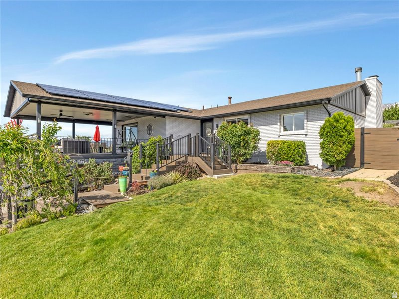 Exceptional Sandy location with rare open space and mountain views. Situated adjacent to open space owned by Pebblebrook Golf Course, this property offers added privacy and a setting that feels expansive and peaceful. Beautiful rose gardens and mature landscaping welcome you as you walk up the stairs to the front entrance, setting the tone for the outdoor spaces that continue throughout the property. Enjoy sweeping valley views and VIP seats to America First Field fireworks from the covered deck above the garage, which wraps around to the backyard featuring a covered pergola, planter boxes, and beautiful Wasatch Mountain views. Offering 5 bedrooms, 3 bathrooms, 2 family rooms, a formal dining room, large laundry room, and timeless potential, this 1975 home provides a unique outdoor lifestyle opportunity in a location that's hard to find. As an added bonus,  with an acceptable offer, sellers will replace the upstairs carpet and hardwood flooring with updated, matching LVP currently used in the basement to create a cohesive feel throughout the home. Flooring replacement can be completed after move-out by a licensed contractor or buyer can use their own contractor to install.  All three fireplaces are electric. Roof installed in 2014 and solar installed 2021, ( solar reduces power bill to $35. per month). Furnace and AC installed 2021, Water heater and water softener installed 2026! Buyer to verify square footage. ALL PATIO FURNITURE INCLUDED WITH THE SALE!