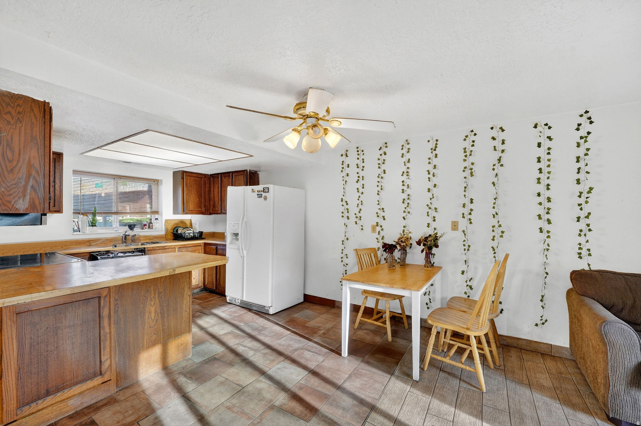 This inviting and budget-friendly 2-bedroom, 1.5-bath corner unit condo delivers comfort, practicality, and a convenient location. It includes an assigned covered parking space and offers quick access to downtown dining, schools, and nearby skiing. The split-entry design features the kitchen, dining, and living areas on the lower level-partially below grade-while both bedrooms are located upstairs. A fully finished basement with a half bath adds extra usable space. Perfect for those seeking a low-maintenance lifestyle, this home blends functionality with close proximity to all that Ogden has to offer. Square footage is provided per MLS guidelines; buyer to verify.