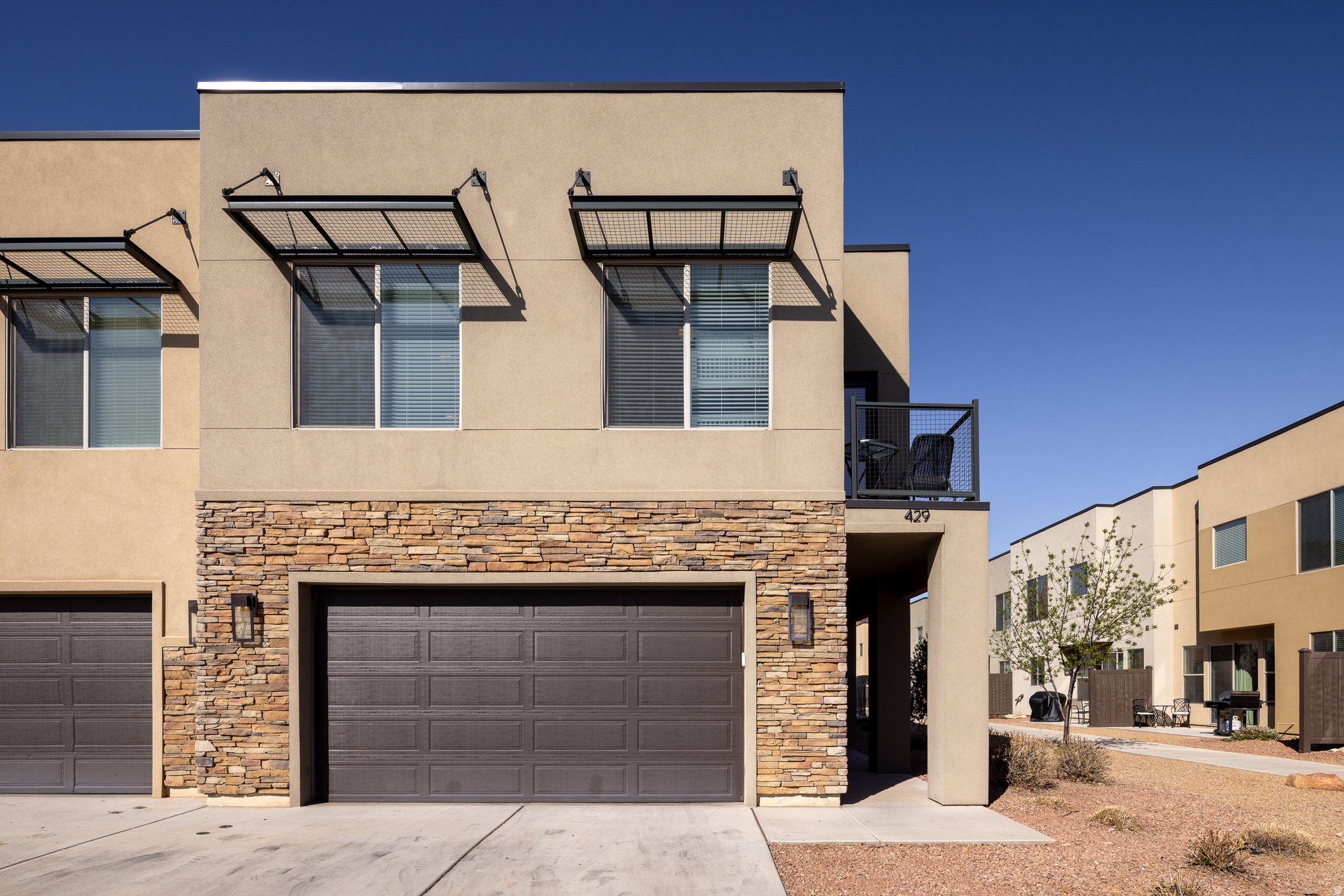 POOLSIDE AT ENTRADA! Welcome to 429 Entrada, a 4-bedroom luxury townhome located within the Moab City limits- centralized between recreational corridors, national parks, city parks and the vibrant downtown scene. The floorplan is open and bright, with a great room comprised of a spacious living area, dining room with patio access, and a beautiful kitchen with bar top seating. There is a 3/4 bath on this main level, and a delightful reading/play nook under the stairs that can be transitioned into a gear room or owner's locked closet if desired. Head upstairs to find four amazing bedrooms, including a gorgeous main bedroom with en suite bath offering a soaking tub, separate shower and walk-in closet. A second full bath with a double-sink vanity room and separate shower room allows for ease of use between the additional bedrooms. Each bedroom offers lush carpet and different sleeping arrangements, with the queen bedroom offering a sweet bistro patio! Expertly furnished and move-in ready this property is being sold complete with all furnishings, dishware, decor, and electronics, making it a perfect turnkey short-term or long-term rental property, as well as the opportunity to enjoy for your own personal use. Entrada at Moab offers sumptuous amenities, including the community pool and heated spa- right out the back door of 429! This stunning vacation home is professionally managed and maintained; it sleeps 14 and has a two-car garage that comes equipped with townie bikes- this is the adventure destination you have long imagined! Square footage figures are provided as a courtesy estimate only and were obtained from images. Buyer is advised to obtain an independent measurement.