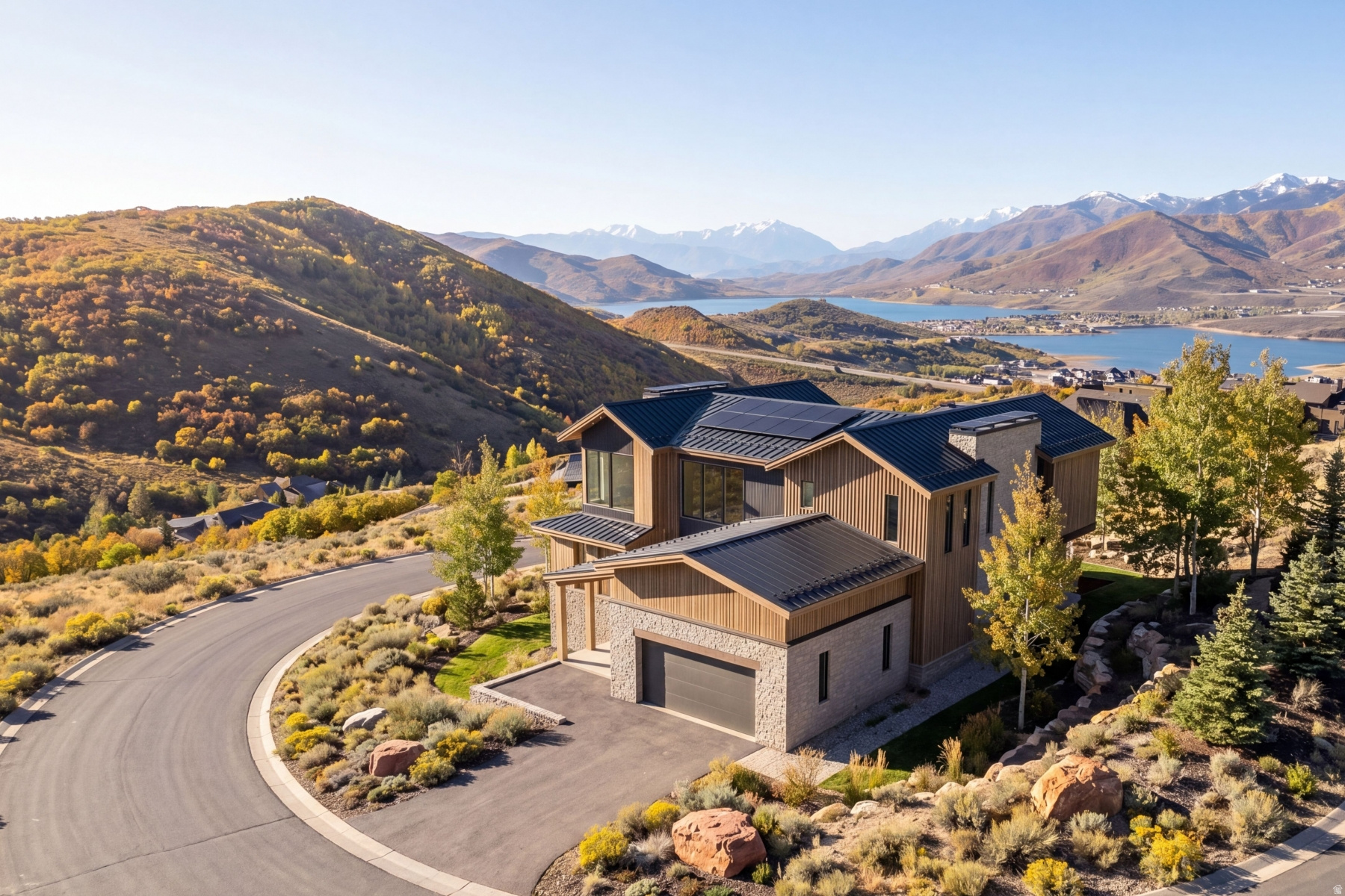 Architectural Masterpiece with Unobstructed Lake & Ski Mountain Views. Set within Soaring Hawk at Hideout, this architecturally refined mountain residence captures sweeping, unobstructed views of the Jordanelle Reservoir, surrounding mountain ranges, and world-class ski resorts. Designed to fully embrace its setting, expansive walls of glass frame the landscape from the great room, kitchen, and primary suite, creating a seamless connection between indoor living and the outdoors. Spanning approximately 3,979 sq ft, the home offers 5 bedrooms and 5.5 bathrooms with 10-foot ceilings and a clean, open-concept layout. The design balances modern simplicity with livability, ideal for both refined entertaining and everyday comfort. The kitchen is appointed with premium Miele appliances and custom white oak cabinetry with a sophisticated wash finish. Spa-inspired bathrooms feature sleek TOTO fixtures, while custom closets and built-ins elevate functionality throughout. Engineered well beyond conventional construction, the home features a fully integrated climate and wellness system designed for performance at altitude, including multi-zone HVAC, ERV fresh air exchange, UVC air purification, and hospital-grade filtration. Warmboard radiant floor heating with 13 zones provides quiet, consistent comfort. A high-performance building envelope with ZIP System sheathing and a ventilated cold roof design enhances energy efficiency, durability, and long-term protection in mountain conditions. The exterior presents a refined modern mountain aesthetic, combining standing seam metal roofing with a curated mix of wood, stone, and aluminum siding. Positioned on a premium corner lot with a gentle slope and full landscaping, the property offers privacy and easy year-round access. Located just minutes from Park City, Deer Valley Resort, and Jordanelle Reservoir, this is a rare blend of architecture, performance, and setting.