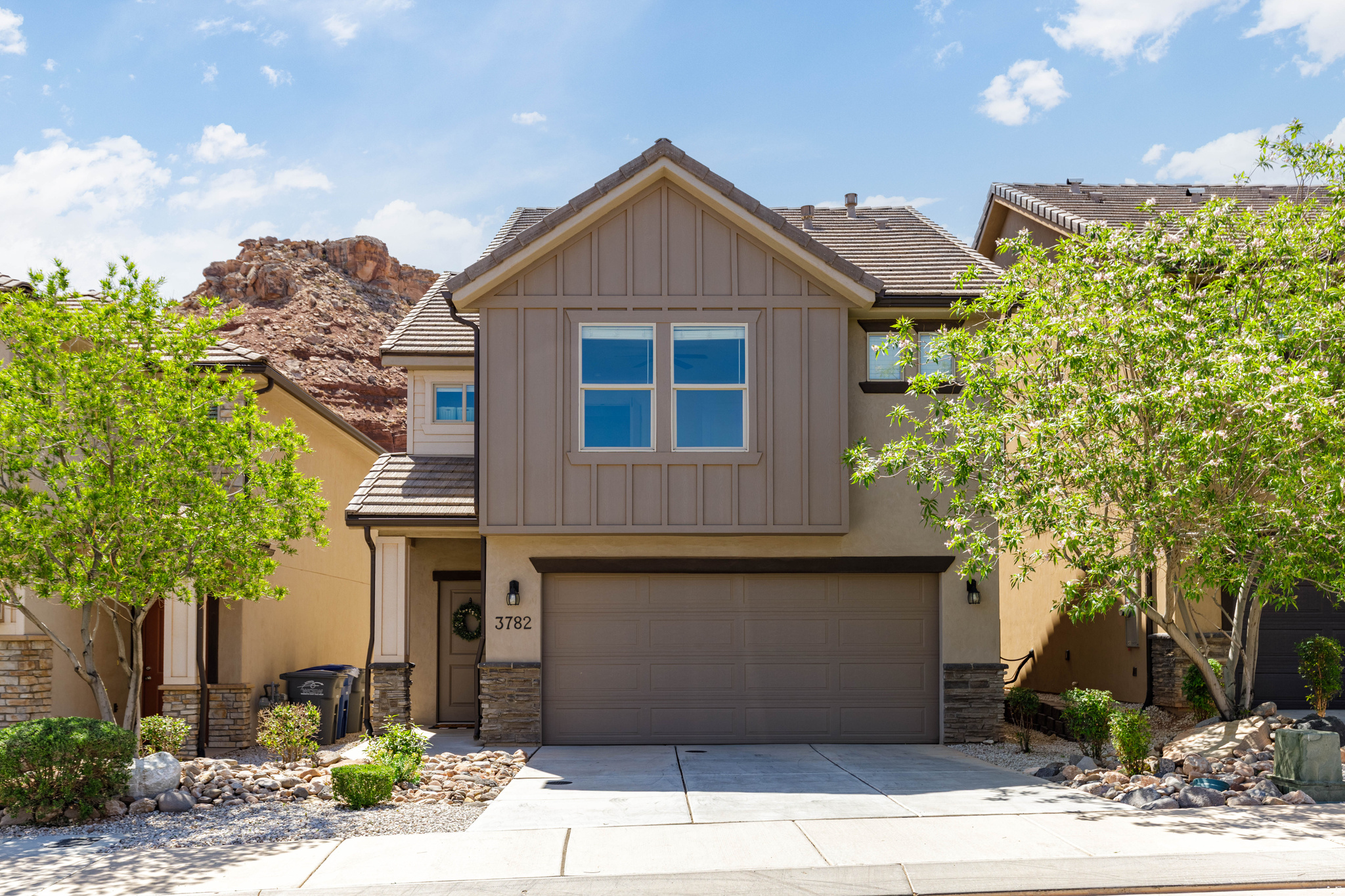 Welcome to stunning red rock mesa views from this charming Desert Canyons gem. This detached townhome combines single-family privacy with the low-maintenance ease and smart, efficient layout of a townhome in a prime St. George location.  Carefully maintained with pride and kept very clean, this move-in-ready home features a bright, open-concept main level with seamless flow between the living, dining, and kitchen areas. The spotless kitchen showcases rich dark alder stacked cabinetry, a crisp white subway tile backsplash, solid granite countertops, stainless steel appliances, and a generous walk-in pantry.  Upstairs, a French door entrance welcomes you into the spacious master suite, complete with a large walk-in closet and dual-sink vanity. The thoughtful second-story layout provides three additional generously sized bedrooms, another full bathroom, and convenient laundry room.  Sunsets painting the mesa create a daily awe-inspiring backdrop, enjoyed from inside the home or the privately fenced backyard with lush artificial turf. Just over the fence sits Broken Mesa Park, offering a playground, covered pavilion, walking paths, and trails. Hitting the sweet spot on location, this home is surrounded by incredible desert landscape, yet minutes from the airport, excellent schools, mountain biking/hiking trails, plus new and upcoming restaurants and entertainment.  Ideal for new homebuyers and investors alike, this home offers strong rental and cash-flow potential. Priced to sell quickly, this well-cared-for detached townhome is an outstanding opportunity you won't want to pass up.