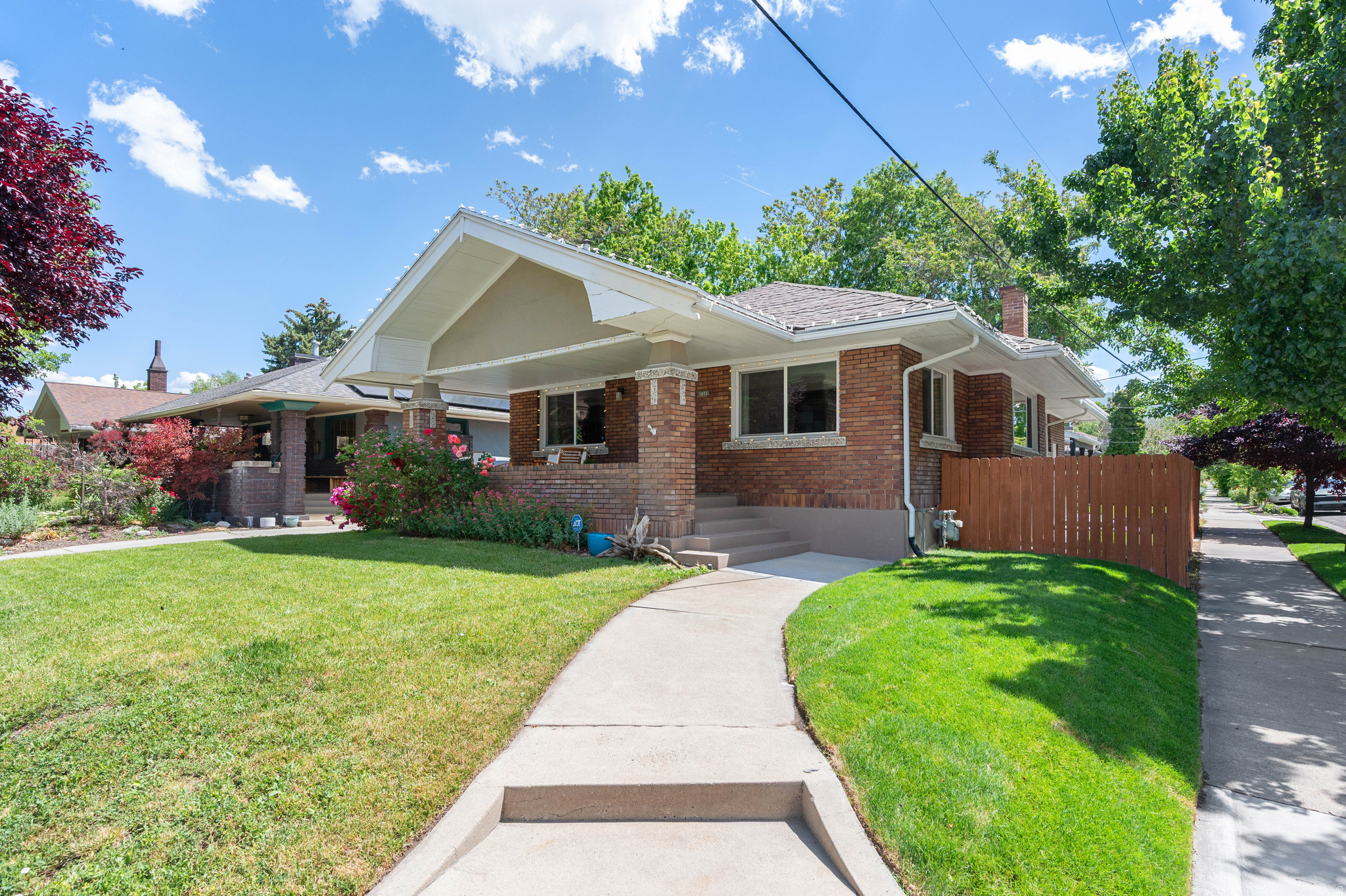 NEW PRICE. SAME CHARM | OPEN SAT 11-1. Vintage meets modern in this fully updated 1922 bungalow, featuring a rare legal Mother-in-Law apartment (ADU) with separate entrance and convenient access to shared laundry. Recent improvements include updated electrical, foundation piers for added structural stability, new sewer liner, and all the pretty finishes: carpet, paint, wallpaper, lighting, hardware, and more. The open-concept main level showcases a show-stopping dining room made for entertaining, gourmet kitchen with granite countertops, stainless steel appliances, farmhouse sink, custom tile, and flex duo oven, walnut flooring, and the rare advantage of three bedrooms on the main floor, each with its own walk-in closet. The oversized primary suite is a retreat of its own, drenched in Farrow & Ball London Clay and featuring a fireplace and sitting area. Outside, the 720-square-foot detached garage parks two vehicles or provides flexible space for a workshop, gym, or studio. Enjoy morning coffee on the front porch as dogs walk their humans by, then retreat to the shaded hammock nook with solar lighting for all-day enjoyment. The perfectly sized backyard offers room to relax without consuming your weekends, while the covered stone patio may have you choosing between hosting or declining plans in favor of staying home. Walk to Trader Joe's, Sugarhouse S-Line, Liberty Park, and to any of the dozens of restaurant nearby! Welcome Home! [Agent related to seller and has an interest in the home.]