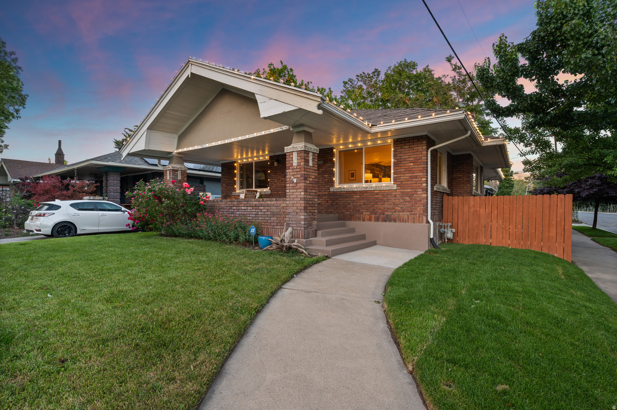 VINTAGE MEETS MODERN in this fully updated 1922 bungalow. Recent improvements include updated electrical, foundation piers for added structural stability, and all the pretty finishes: carpet, paint, wallpaper, lighting, hardware, and more. Featuring a rare legal Mother-in-Law apartment (ADU) with separate entrance and convenient access to shared laundry. The open-concept main level showcases a show-stopping dining room made for entertaining, gourmet kitchen with granite countertops, stainless steel appliances, farmhouse sink, custom tile, and flex duo oven, walnut flooring, and the rare advantage of three bedrooms on the main floor, each with its own walk-in closet. The oversized primary suite is a retreat of its own, wrapped in rich tones and featuring a fireplace and sitting area. Outside, the 720-square-foot detached garage parks two vehicles or provides flexible space for a workshop, gym, or studio. Enjoy morning coffee on the front porch as dogs walk their humans by, then retreat to the shaded hammock nook with solar lighting for all-day enjoyment. The perfectly sized backyard offers room to relax without consuming your weekends, while the covered stone patio may have you choosing between hosting or declining plans in favor of staying home. Walk to Trader Joe's, the Sugarhouse S-Line, to Liberty Park, and to any of the dozens of restaurant nearby! Welcome Home! [Agent related to seller and has an interest in the home.]