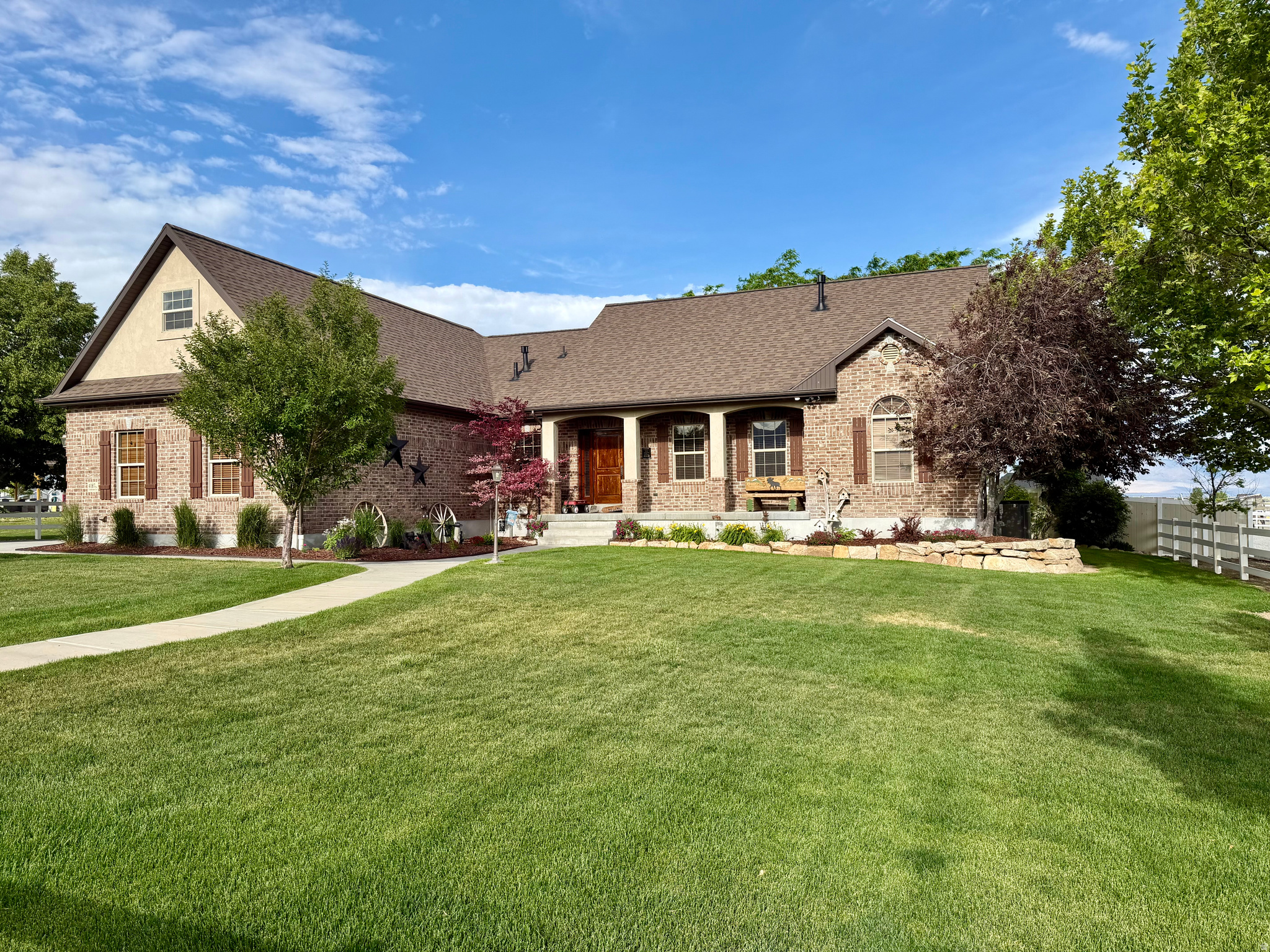 Country living at its finest! This beautifully upgraded homes sits on 2 professionally landscaped acres designed perfectly for horse lovers. Enjoy two pasture areas, a horse walker, round corral, outdoor riding arena, 2 covered stalls with a Nelson waterer, and additional hay storage, tractor storage, covered storage (or an extra 4 stalls there is a hydrant and an additional Nelson waterer that will service these stalls.)  and a lockable tack room with a yard light. All the horse fencing is RAM strap with hot wire.  The property also features a 16' by 20' shop with a 16' by 10' covered patio overlooking raised garden beds with auto drip system and a small fruit tree orchard. The yard is set up for a trailer, water and power hook ups, 5 water hydrants, Natural gas hook up for barbecue.  Inside you'll love the custom cabinetry, granite countertops, travertine flooring,  Stainless GE cafe appliances range, dishwasher, microwave and refrigerator and a warming drawer. A cozy fireplace in the family room. The spacious primary suite opens to the back patio and includes a luxurious bath with walk-in shower, soaker tub, generous counter space and a large  organized walk-in closet.The mudroom is large and has great storage along with having a shower making it easy to clean up after working outside.  Upstairs offers a large bonus room ideal for an office, family room or bedroom. The basement includes an exterior entrance, dining room with fireplace and controllable thermostat.  beautiful cherry kitchen, travertine floors, granite countertops, GE stainless appliances, range, dishwasher, microwave and refrigerator. The family room has 7 in 1 stereo speakers with cat 5 system.  two additional bedrooms one with a walk in closet. There's also a great workshop and storage space 9' x44' - Under the front porch storage space 4' x 12'. Also included water softener, the water heater has recirculating heat pump and the HVAC is high efficiency. The well pump is a variable pump water filter and surge tank. This home has  great ADU potential. The incredible property must be seen to be appreciated!! "NEW ROOF IN 2025 with a transferable warranty!! and a RADON MITIGATION SYSTEM!" There is an extra power box by round pen for future building. There is a light by the round pen for night time use. (There are 5 hydrants on the property - side road, walker, back pasture, hay barn, orchard) The pastures have full sprinklers systems with timers. The garden is on a drip system with a timer.