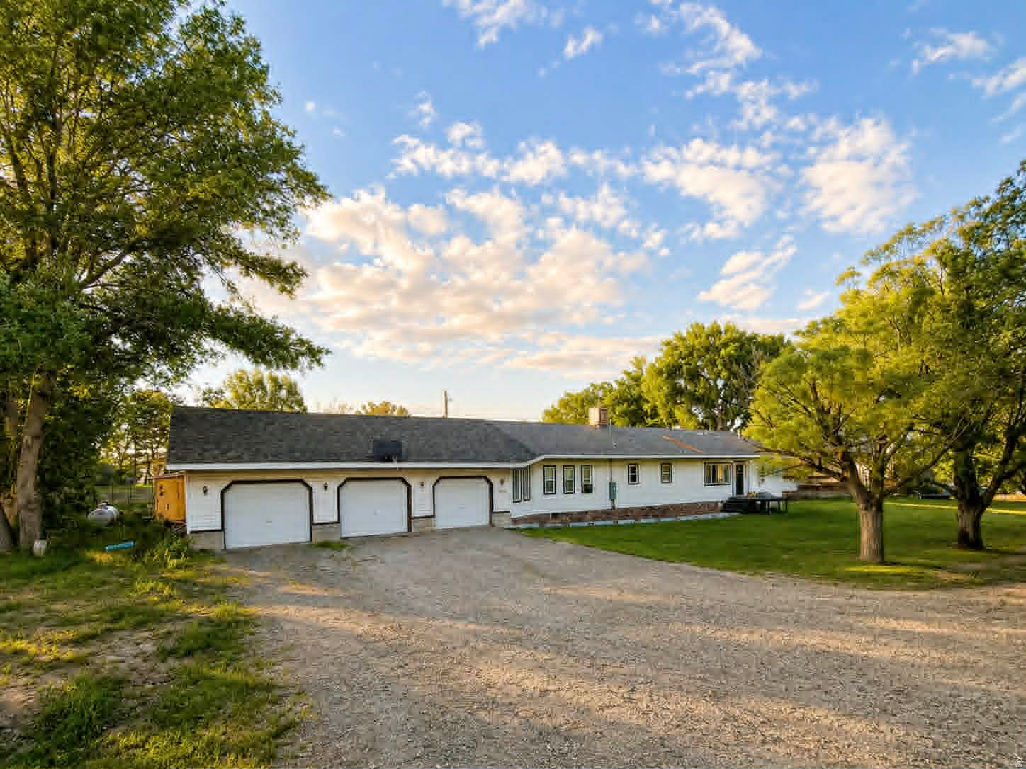 Welcome to your own slice of country paradise! Situated on 2.81 acres, this beautifully updated 5-bedroom, 4-bath home offers the perfect combination of space, comfort, and functionality. Inside, you'll find an expansive floor plan featuring large living area, a spacious dining room, and a stunning kitchen complete with abundant cabinetry, island seating, tile backsplash, and modern finishes. The primary suite offers a private retreat with a massive walk-in closet and ensuite bath.  Throughout the home you'll appreciate updated flooring, recessed lighting, custom wainscoting, accent walls, and modern black doors and hardware that add character and style. The oversized laundry room provides additional storage and convenience. Outside, enjoy mature trees, wide open spaces, fenced yard areas, room for animals, equipment, RV parking, and all the toys. The attached 3-car garage offers exceptional space with extra height/length/width for vehicles, storage, hobbies, or a workshop. Whether you're entertaining on the covered patio, enjoying the peaceful setting, or taking advantage of the acreage, this property delivers the country lifestyle you've been looking for while still offering all the comforts of a beautifully updated home.  Square footage figures are provided as a courtesy estimate only and were obtained from Cubicasa .  Buyer is advised to obtain an independent measurement.