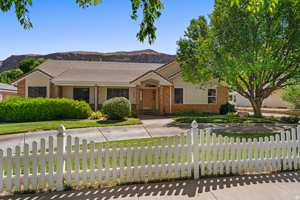 Discover your ultimate Southern Utah lifestyle in this rare main-level living masterpiece with upgrades inside and out. Located on the serene Sycamore Lane within Roberts Ranch Estates, this immaculate .60-acre estate offers breathtaking views and a coveted east-facing backyard for shaded afternoon relaxation--all with NO HOA.  With nearly 4,000 sq. ft. of living space, this home features a spacious open floor plan. The main level includes 3 bedrooms and 2 baths, while the finished basement provides 3 additional bedrooms, a family room, and a versatile hobby or flex-room--perfect for an art studio, quilting room, or home office. Flex room could be converted to kitchenette with the available 220 power.  The park-like grounds are a private orchard paradise featuring peach, apricot, almond, and pomegranate trees. Adventure-ready with an oversized detached metal carport providing sought-after covered RV parking or for your boat or toys. Enjoy the peace of the Hurricane Fields with quick access to Sand Hollow and Zion National Park. Your turn-key home or retreat awaits!