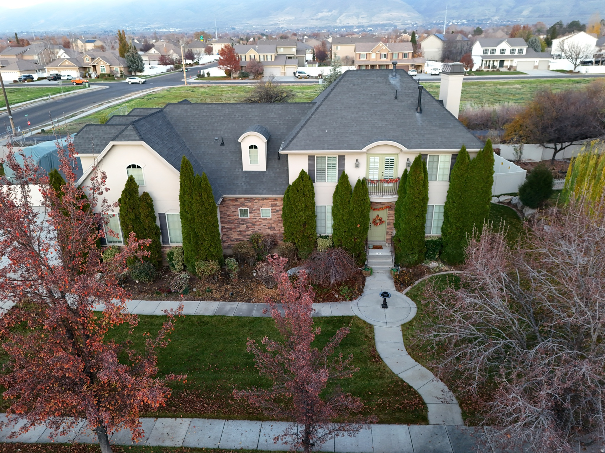 Beautifully maintained home on -acre corner lot with mountain views, fenced RV parking, and access to outstanding neighborhood amenities in one of the area's most desirable communities.  The main living area features tall ceilings and large windows that bring in great natural light and create an open feel. The kitchen offers ample cabinetry, a large island, and double ovens, and a large pantry making it a great space for cooking and gathering.  Upstairs, the spacious primary suite includes a large soaking tub, separate shower, and plenty of room to relax. Unique ceiling lines throughout the second floor add character and interest to the space. The unique laundry room, sitting area and large bedrooms make the upstairs the perfect cozy living area.  The finished basement includes a bedroom with its own bathroom and an adorable kitchenette, providing flexible space for guests or extended living. The home also offers great storage throughout and a convenient mud room.  The HOA includes two pools, pickleball courts, tennis courts, green space, and walking trails, adding to the lifestyle this neighborhood offers.