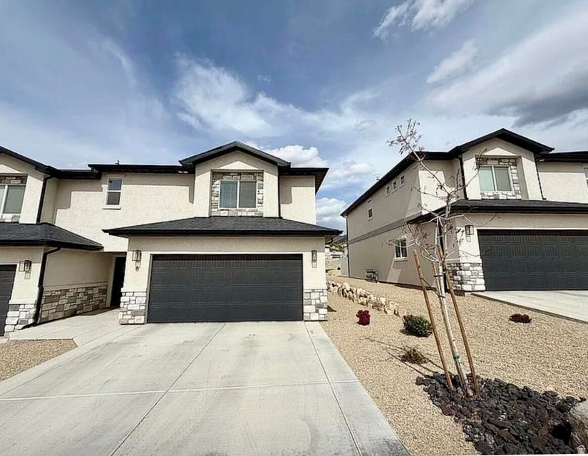 Welcome to this beautifully maintained 3-bedroom, 2.5-bath end-unit townhome offering 1,734 square feet of thoughtfully designed living space. Ideally situated with Cedar City's stunning mountain backdrop and backing directly to a quiet, scenic community park, this 2022 built home feels brand new throughout, with high quality finishes in every room. As an end unit, you'll enjoy extra privacy and natural light, plus the added benefit of 2x6 exterior wall construction, giving you superior sound insulation between neighbors that's hard to find in townhome living. The community also offers generous extra parking, a real convenience for residents and guests alike.  Step outside to the oversized back patio, a rare find for a townhome. Backing up to the community park's green space, it creates the feel of a private backyard retreat, perfect for morning coffee, evening relaxation, or entertaining, all with peaceful views and no rear neighbors.  Inside, the layout maximizes both function and flow, with modern finishes throughout that make this home truly move-in ready. From the quality construction to the unbeatable location against the mountains, this townhome offers a rare combination of privacy, space, and low maintenance living.